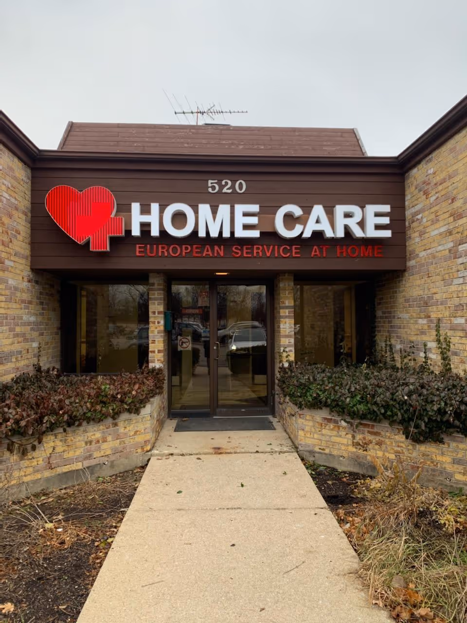 Front view of a building entrance with a large HOME CARE sign.