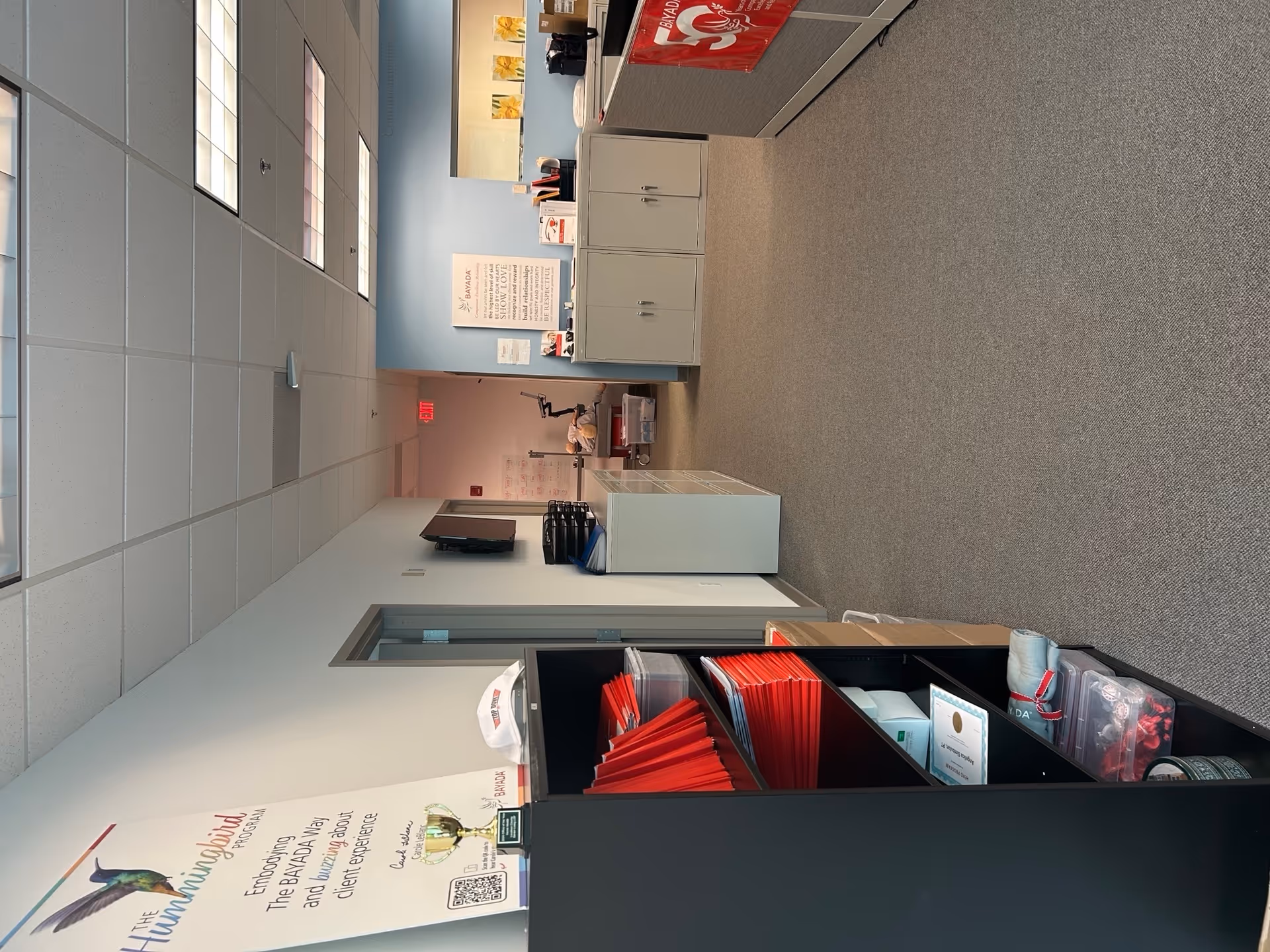 Interior office area at BAYADA Home Health with cabinets and posters.