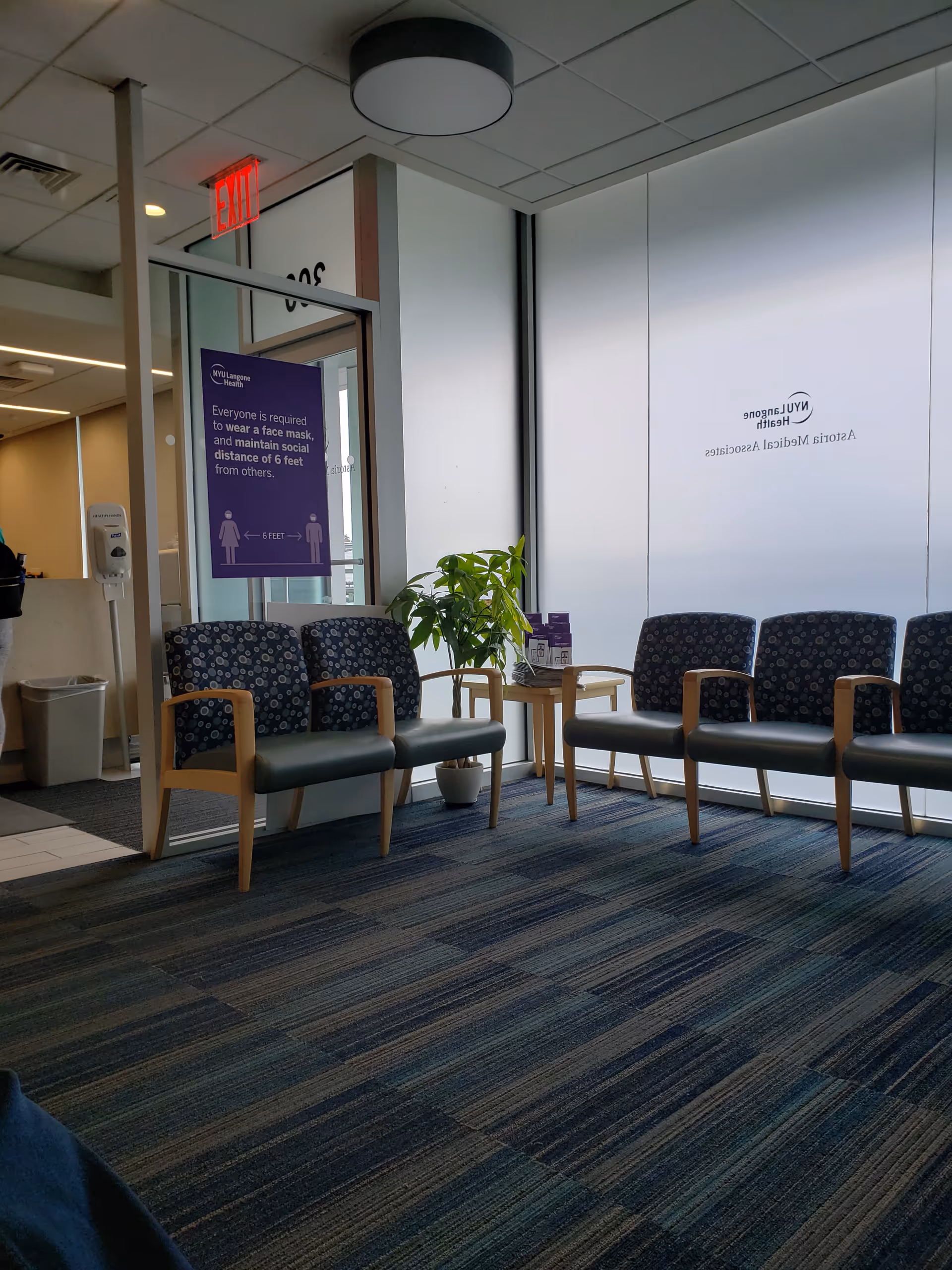 Interior waiting area at NYU Langone Astoria Medical Associates with chairs and plant.