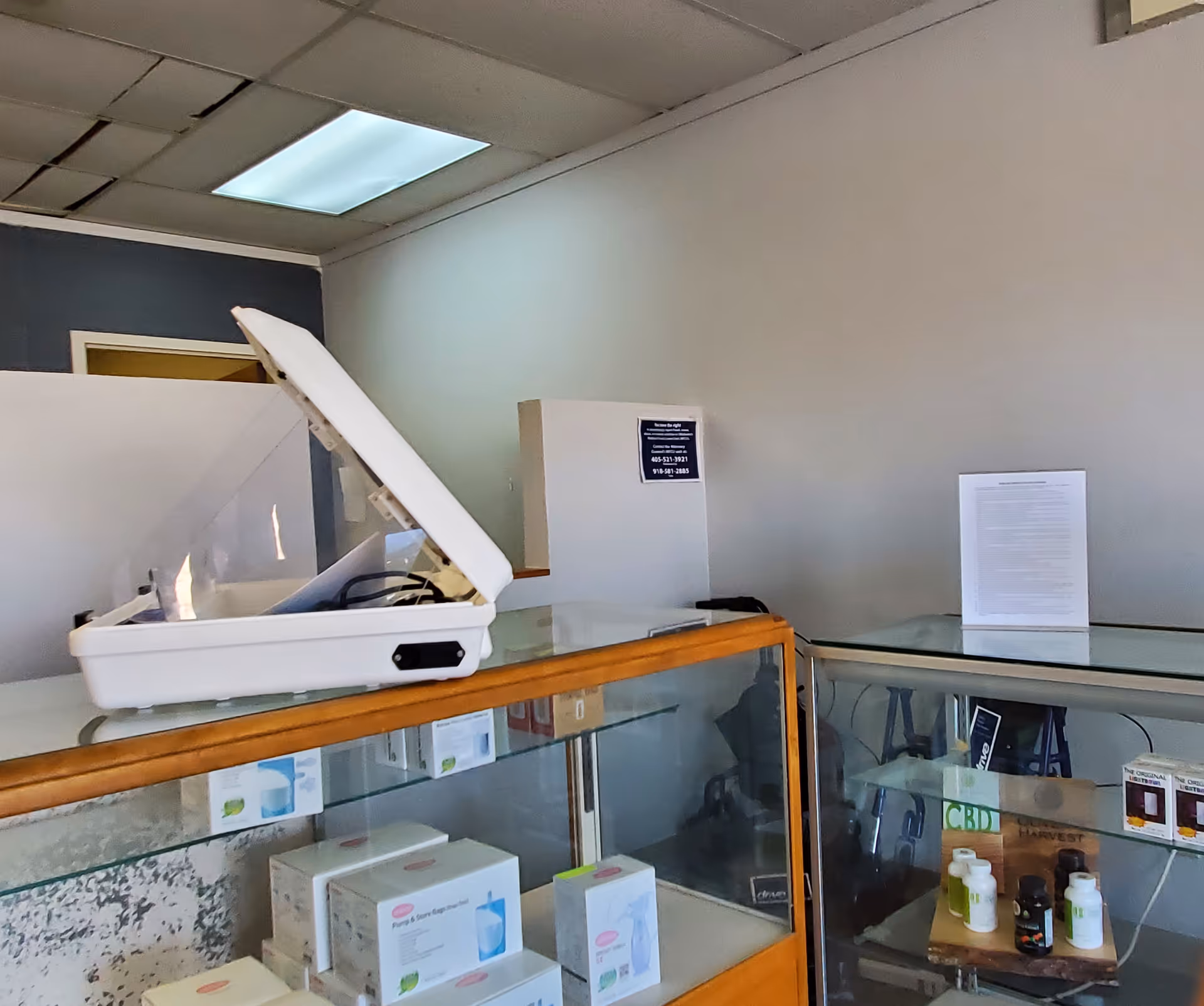 Interior counter area with a white scale and glass display cases.