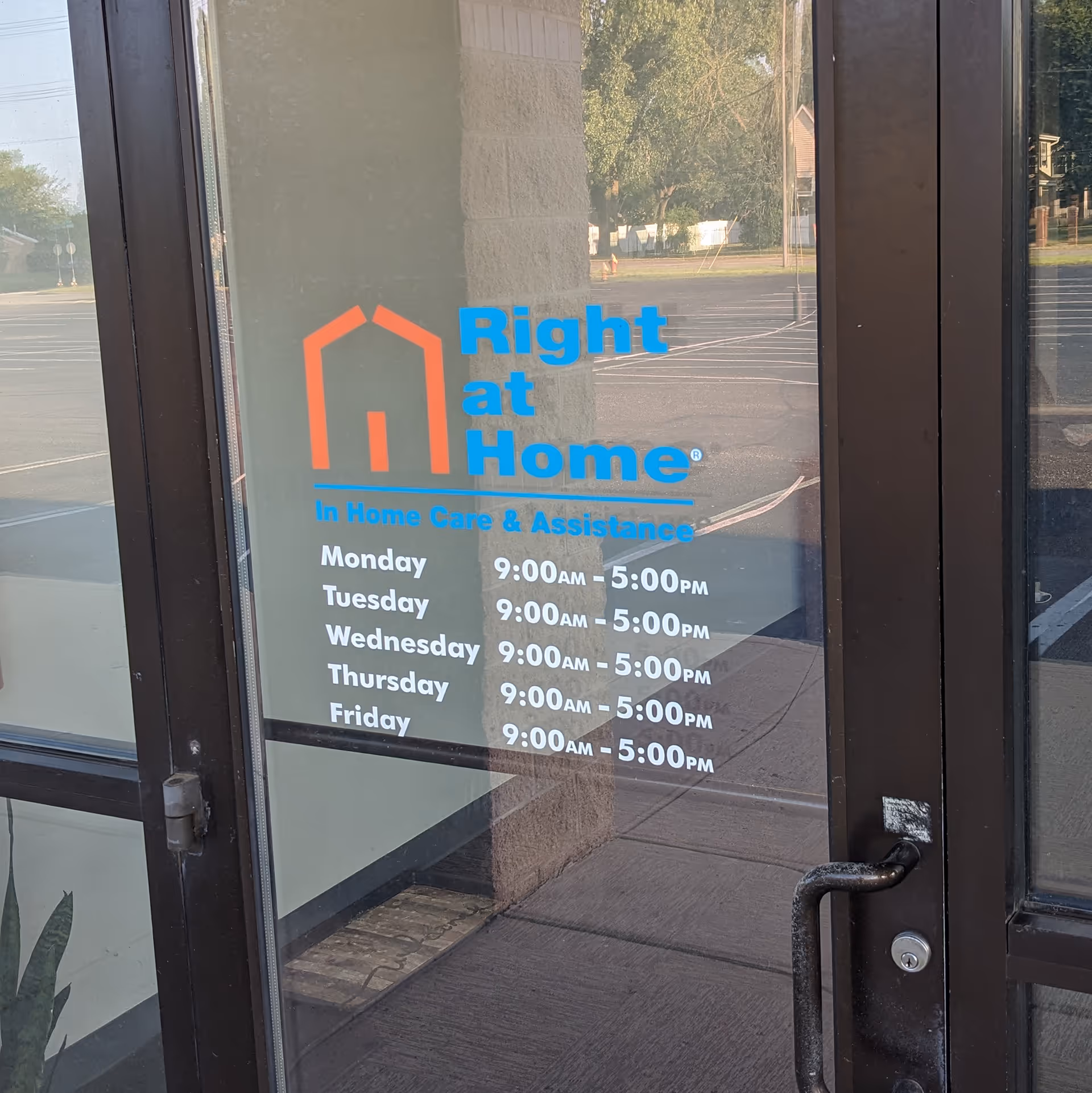 Exterior glass door displays Right at Home logo and posted hours.