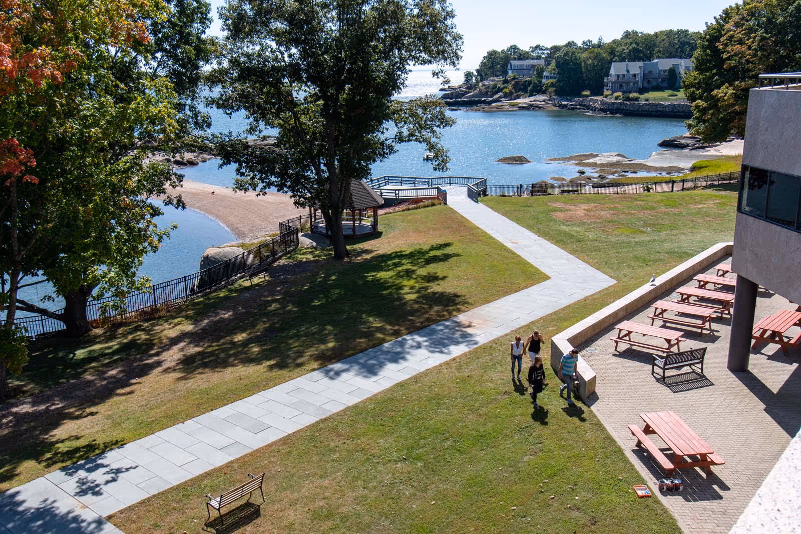 Aerial view of Connecticut Hospice grounds by the water, with walkways and seating.