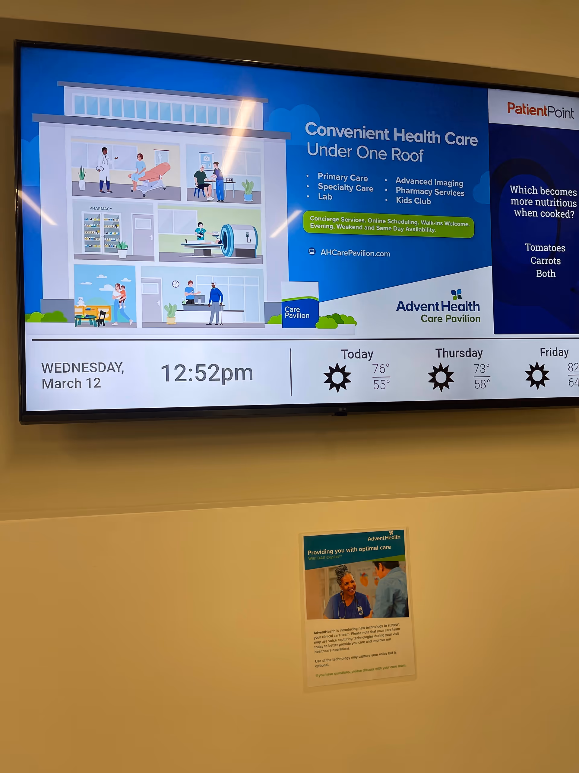 Large indoor wall screen displaying a healthcare infographic and weather forecast.