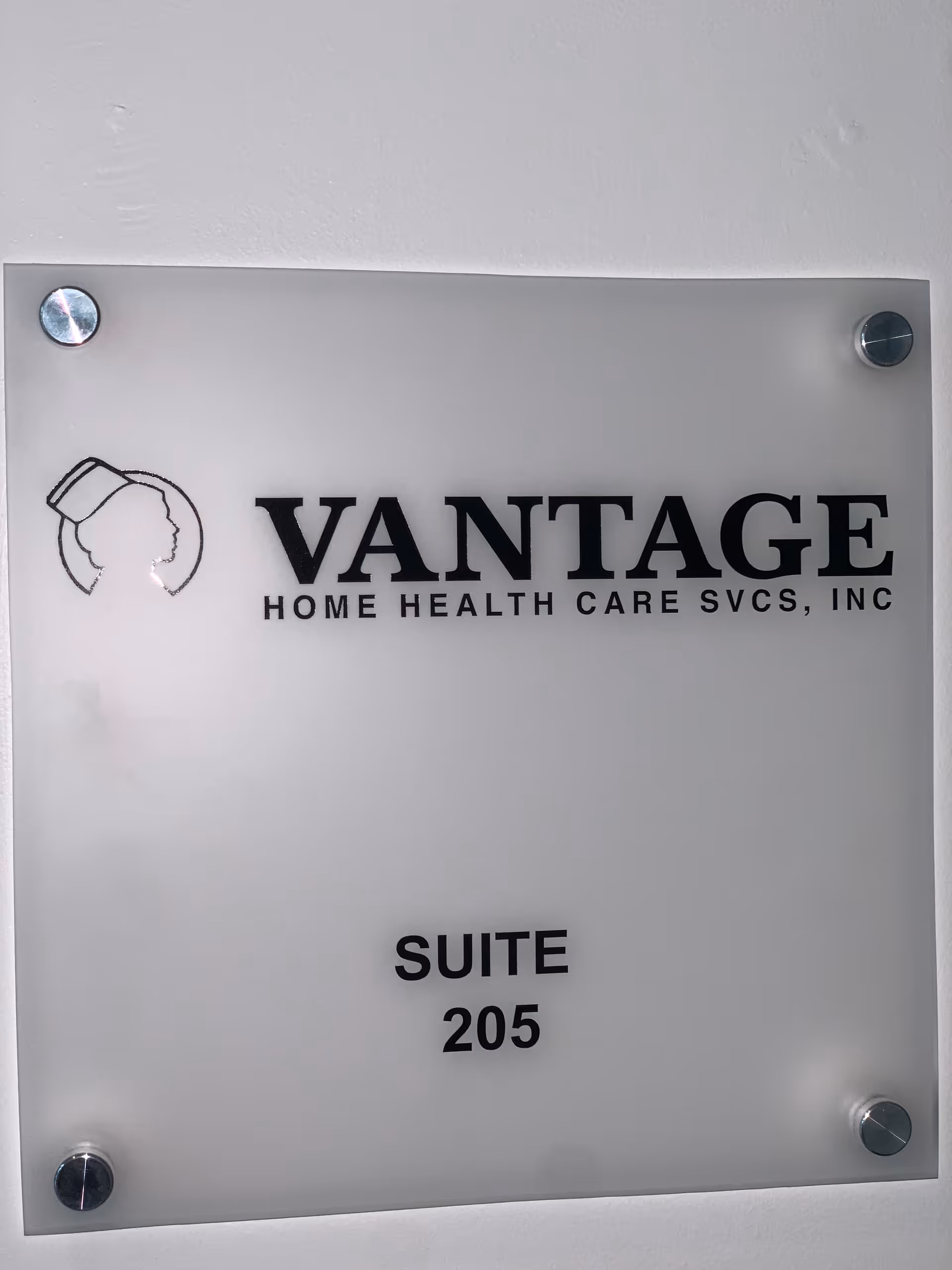 Frosted glass wall plaque displaying Vantage Home Health Care Services and Suite 205