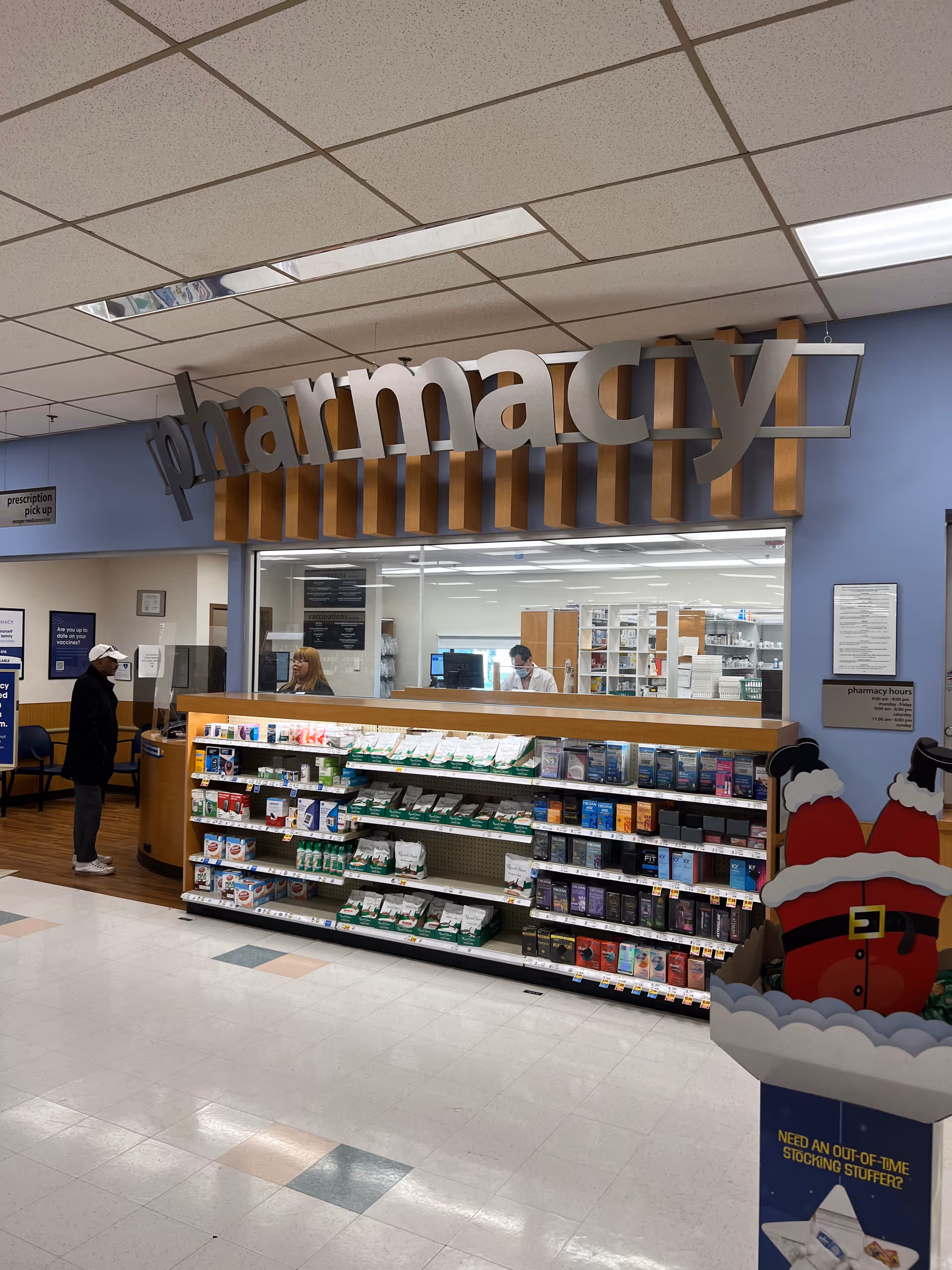 Indoor Kroger Pharmacy in a senior living facility with shelves and staff at a counter.