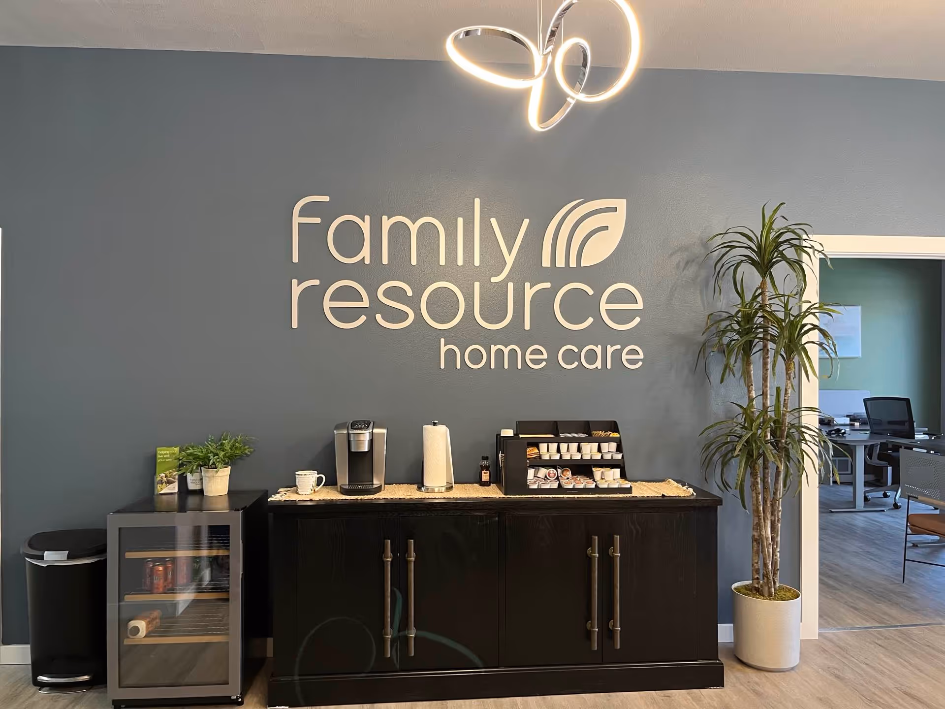 Reception area with a large 'Family Resource Home Care' sign and coffee station.