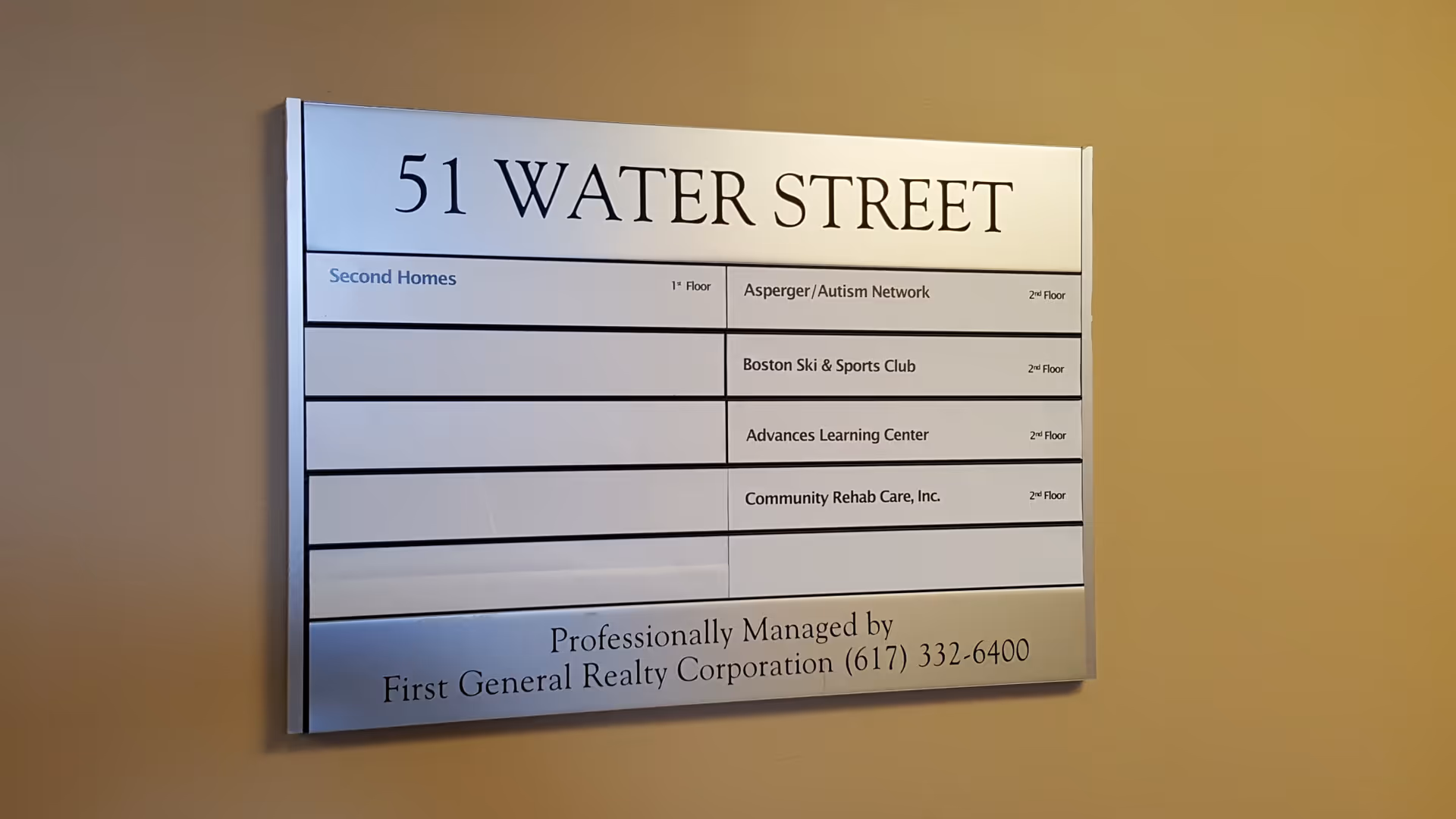Indoor wall directory sign displaying 51 Water Street with multiple tenant listings.