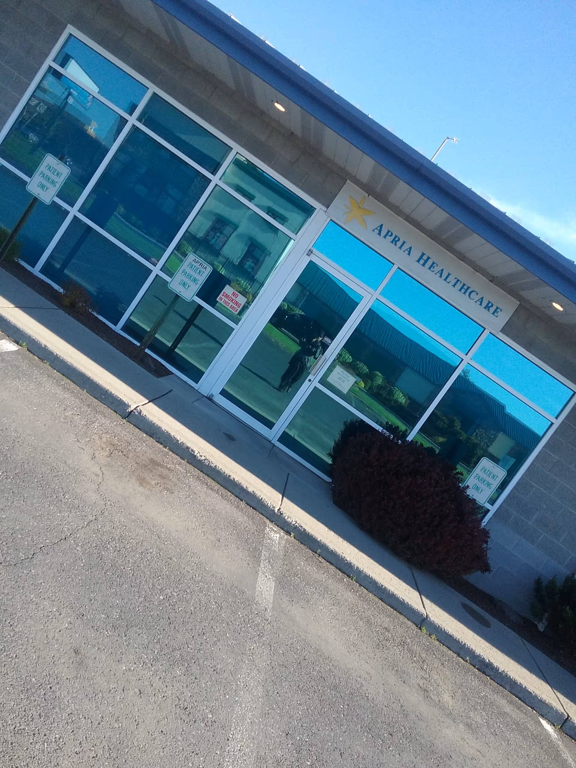Front view of Apria Healthcare entrance with glass doors and windows.