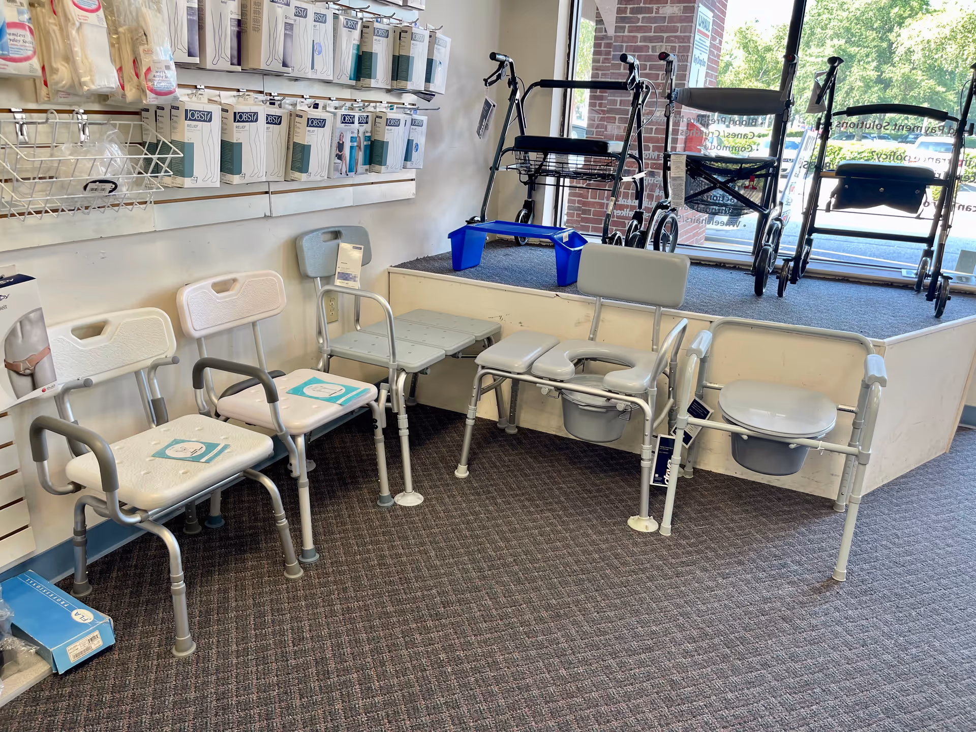 Interior showroom displaying mobility chairs, walkers, and medical supplies.