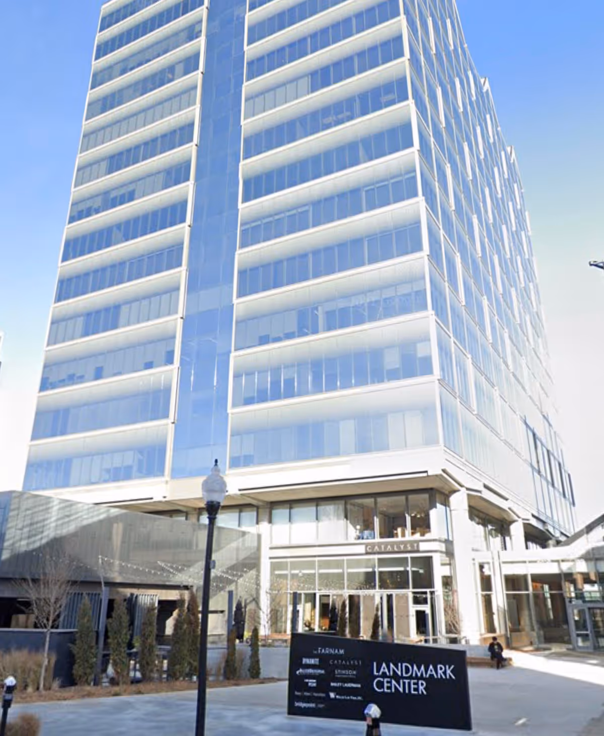 Tall glass-fronted modern building with a visible entrance labeled Landmark Center.