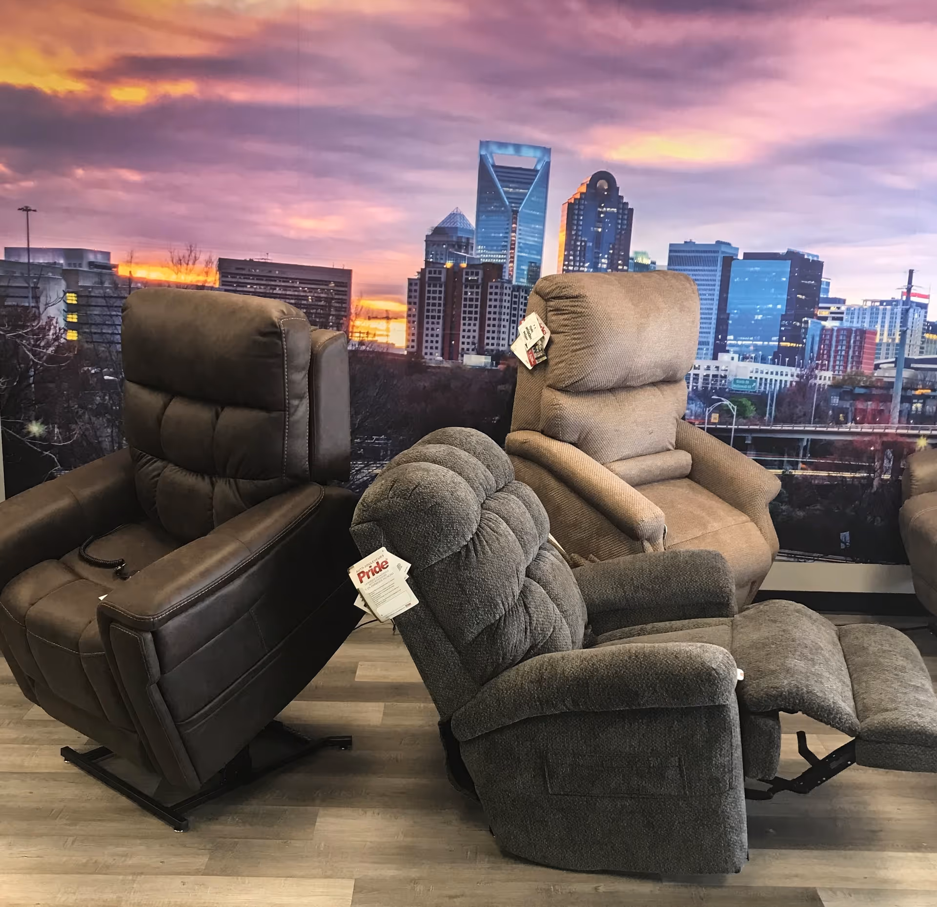 Several reclining chairs displayed in a showroom with a city skyline mural.