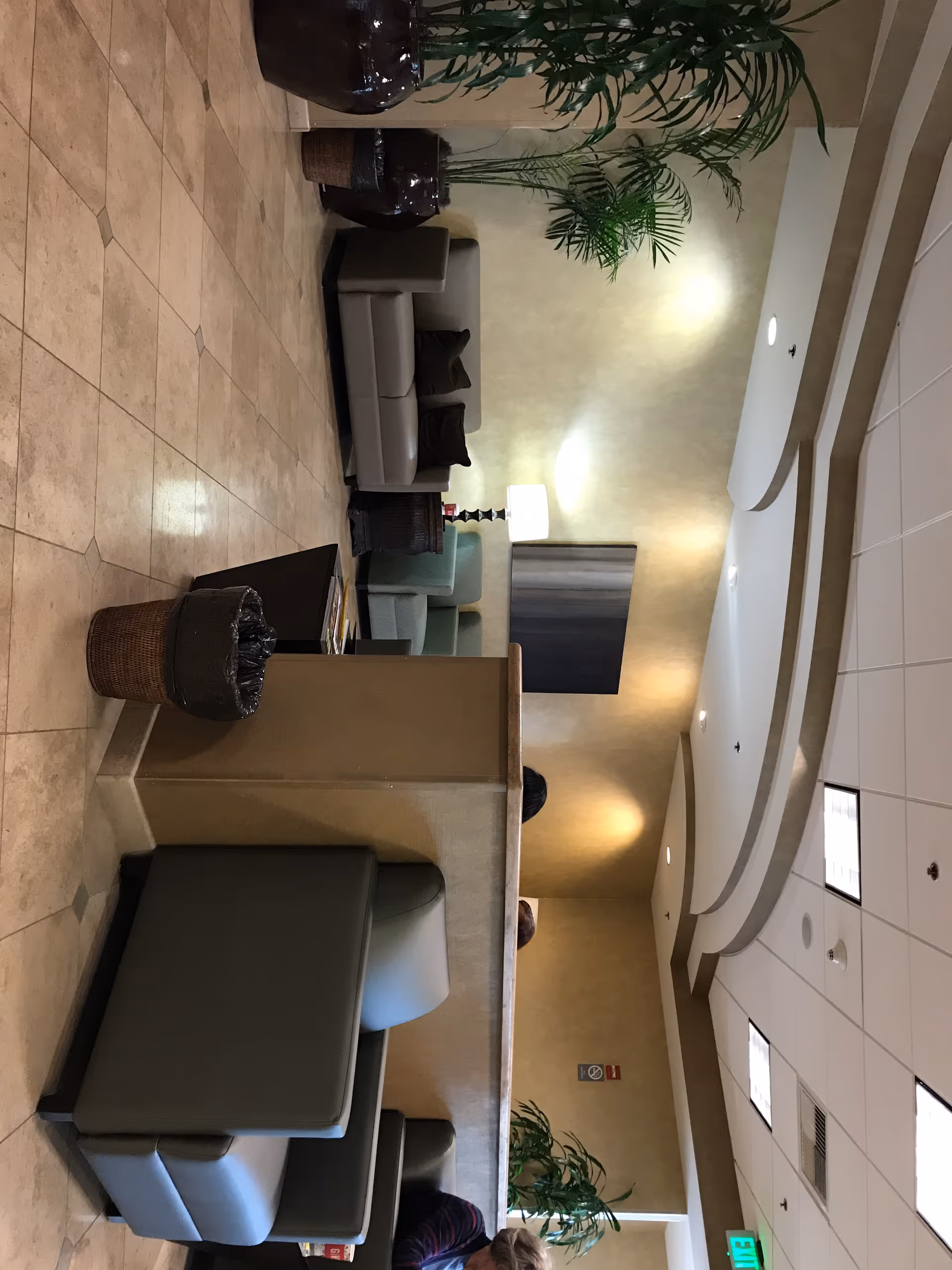 Senior living facility lobby with beige walls, curved ceiling, and lounge seating.