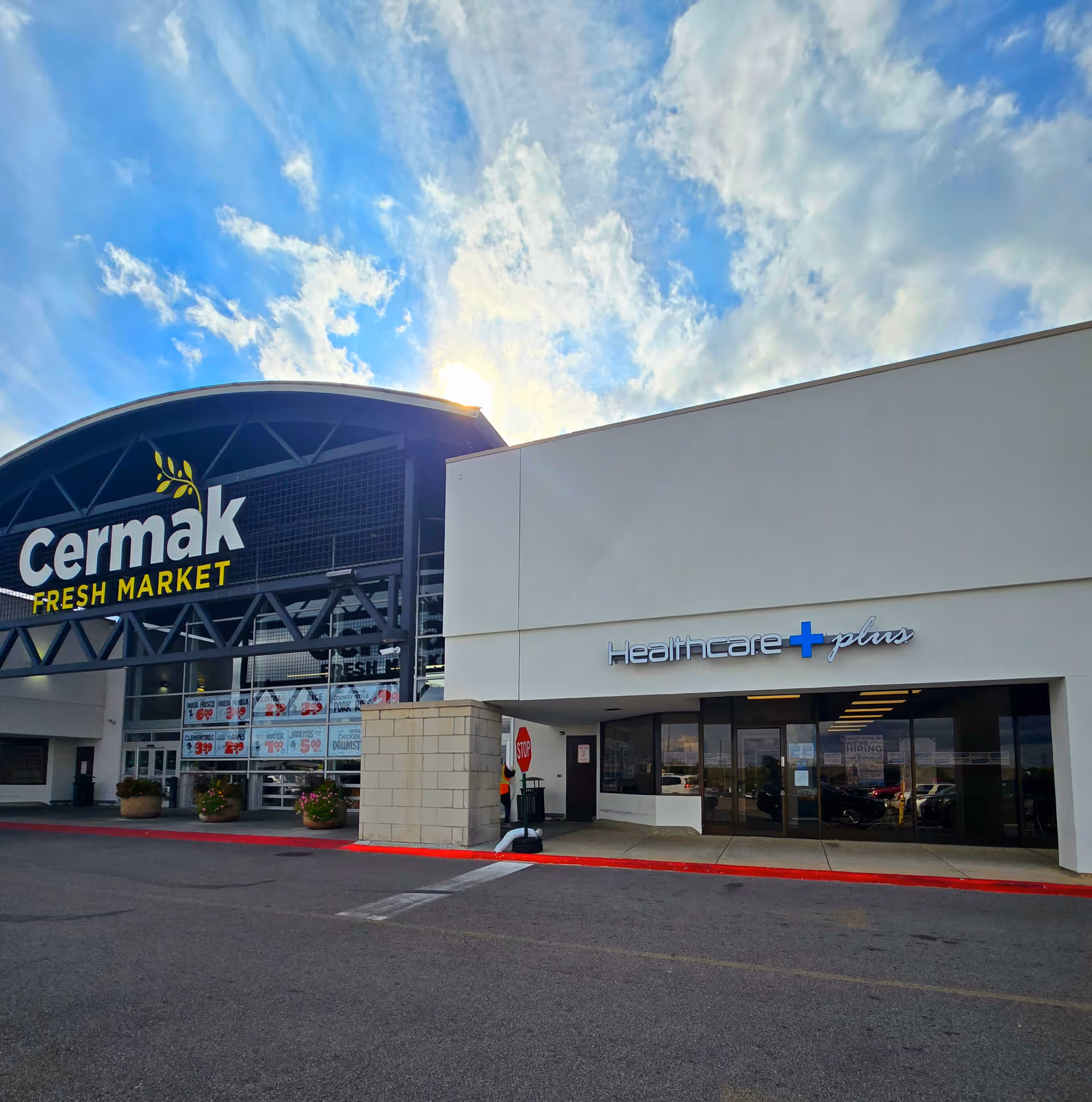 Exterior storefront view featuring Cermak Fresh Market and Healthcare Plus signage.