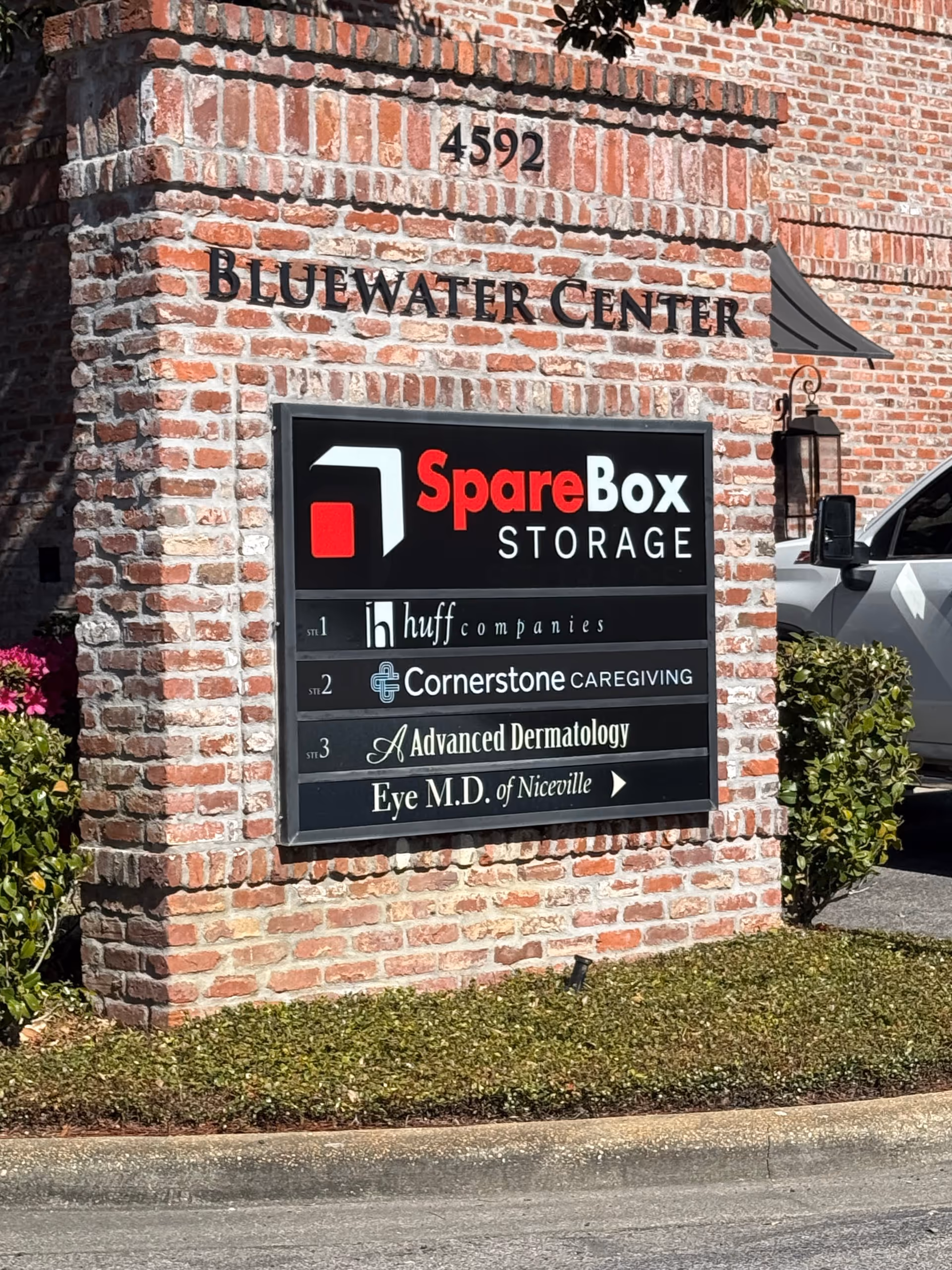 Brick building front sign lists Bluewater Center, SpareBox Storage, and Cornerstone Caregiving.