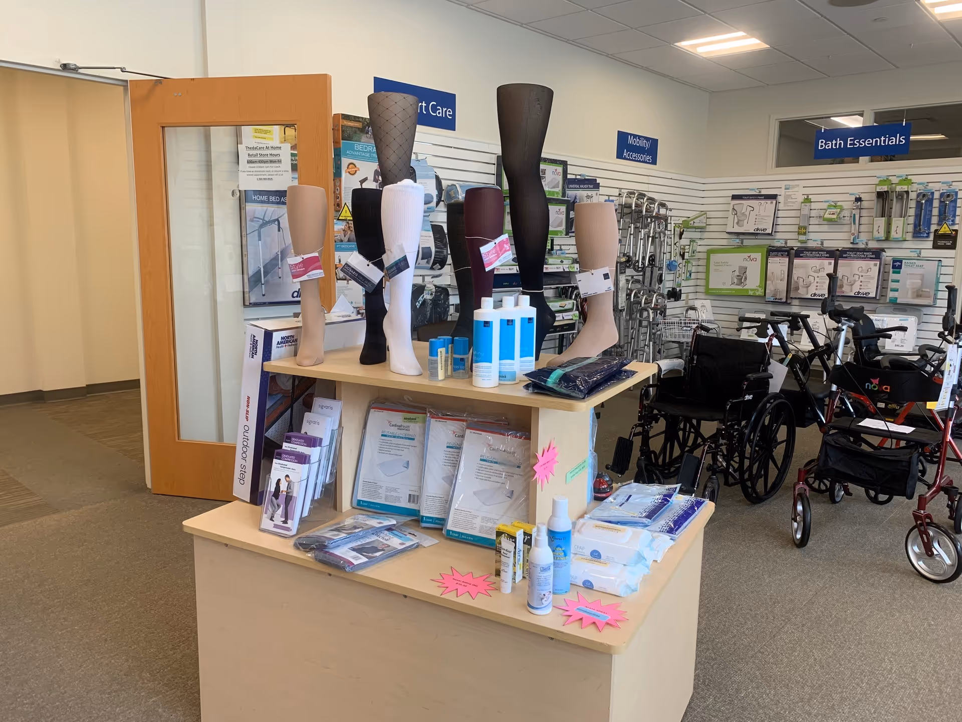 Display counter with mannequin legs, medical supplies, and mobility devices inside a senior care store.
