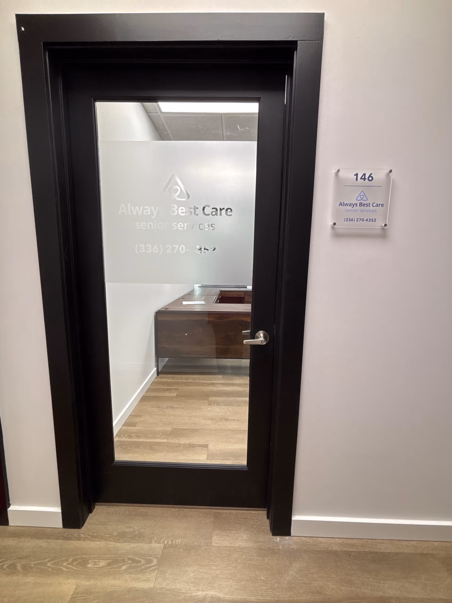 Interior door with frosted glass and Always Best Care signage, hallway visible behind.