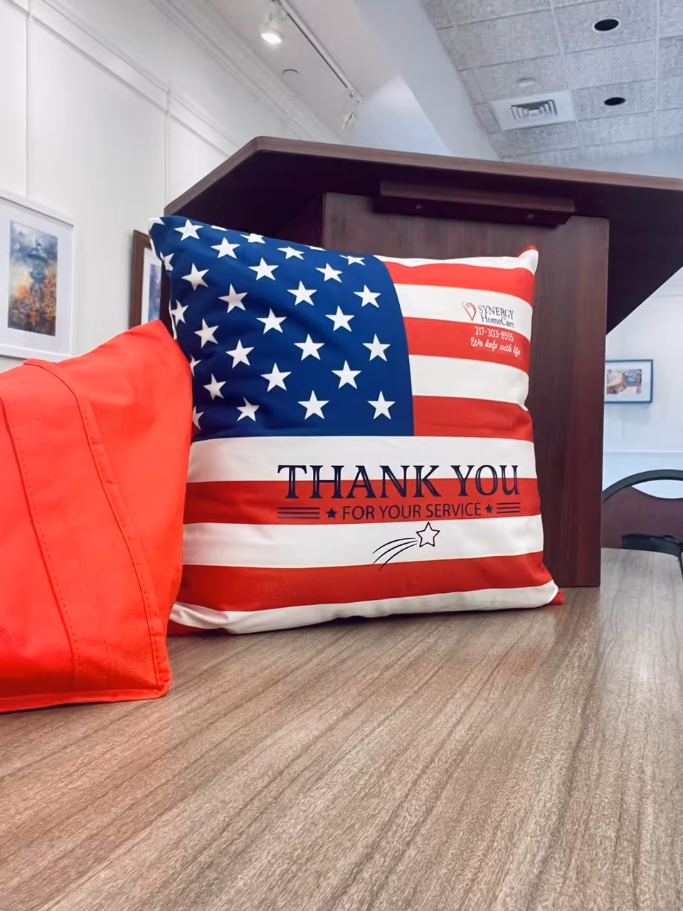 American flag-themed pillow reading 'Thank You for Your Service' on a counter.