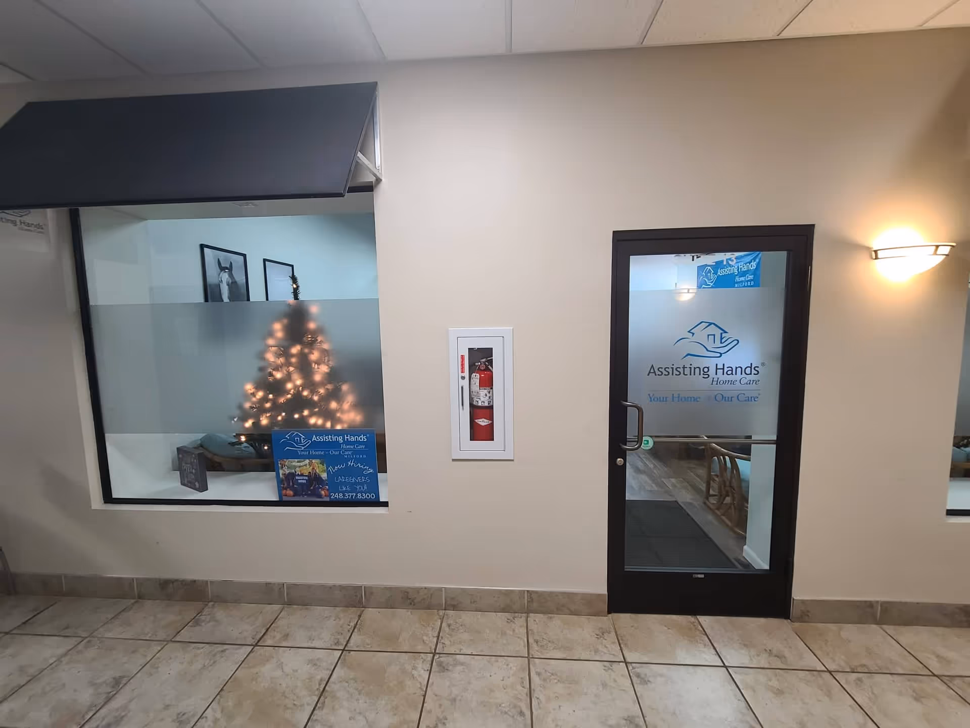 Indoor entry of Assisting Hands Home Care with window display and glass door signage.