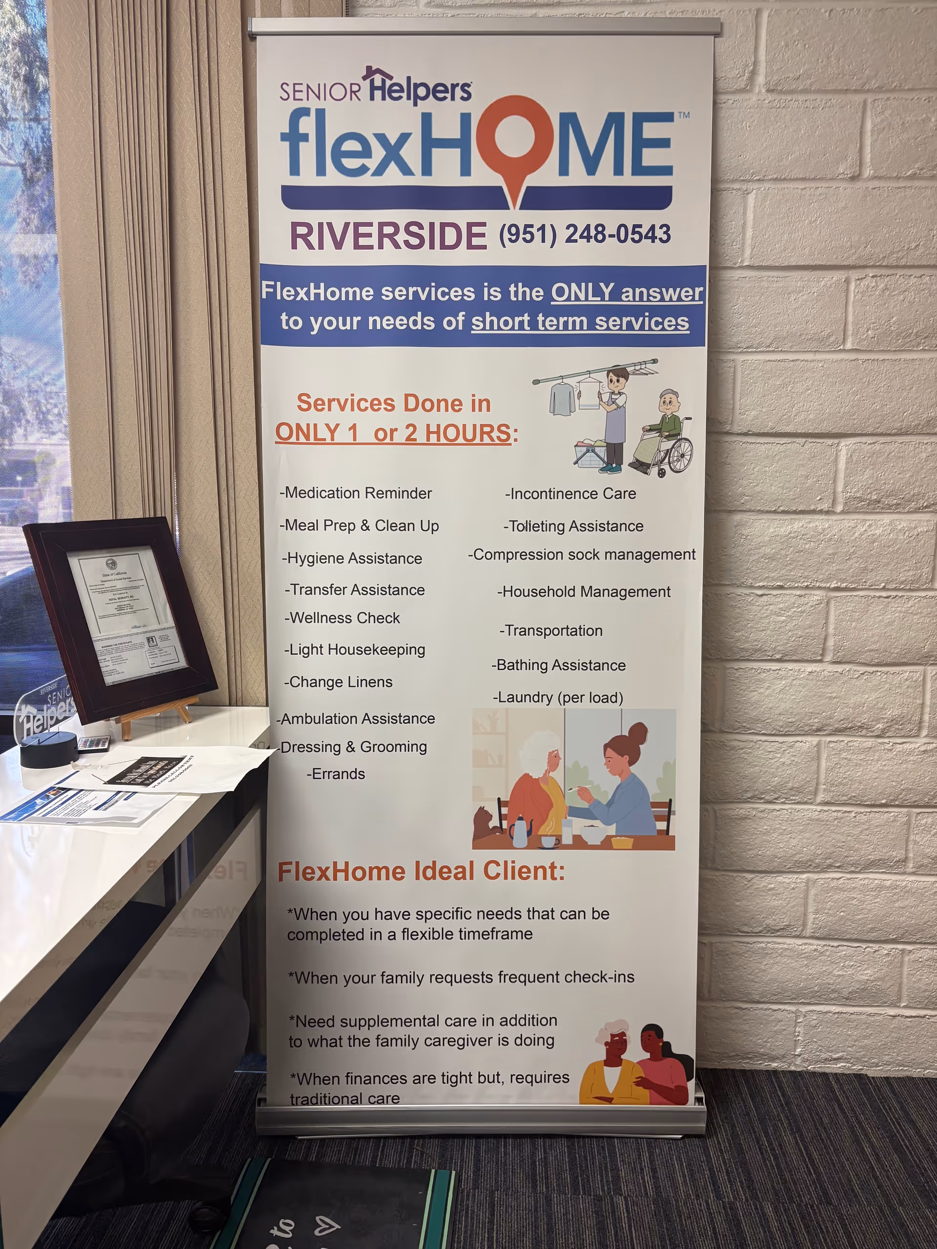 Indoor space with a Senior Helpers flexHOME Riverside banner and a framed certificate.
