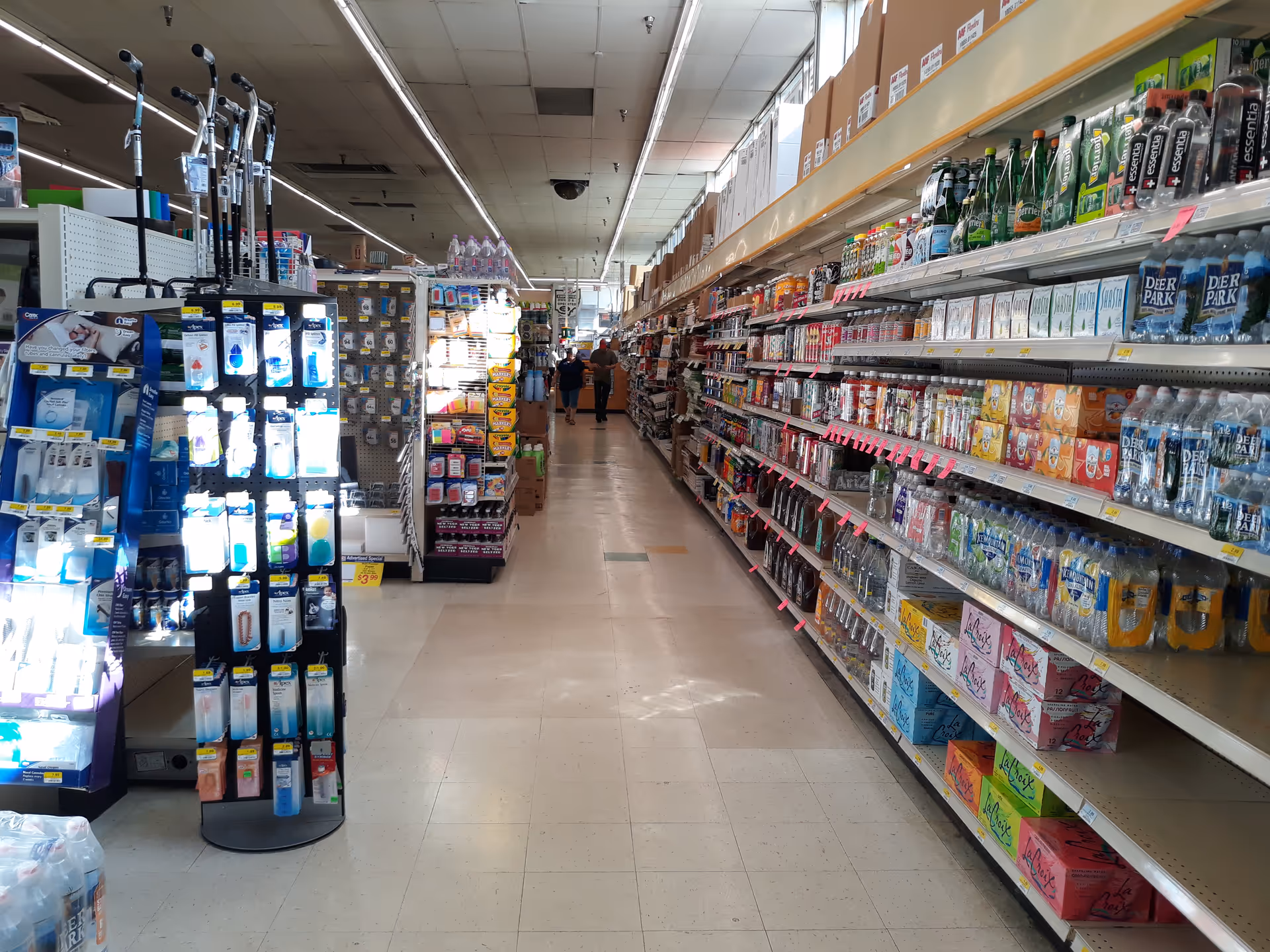 Interior of Discount Drug Mart with a long aisle and shelves stocked with items.