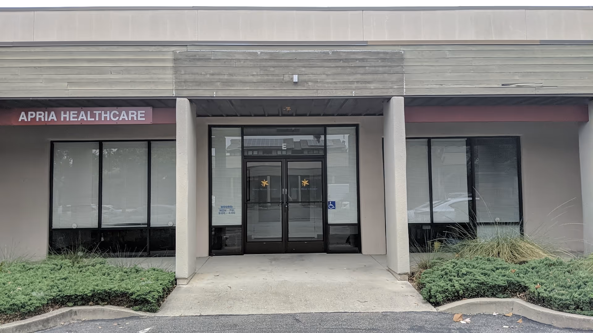 Exterior view of Apria Healthcare facility entrance with glass doors.