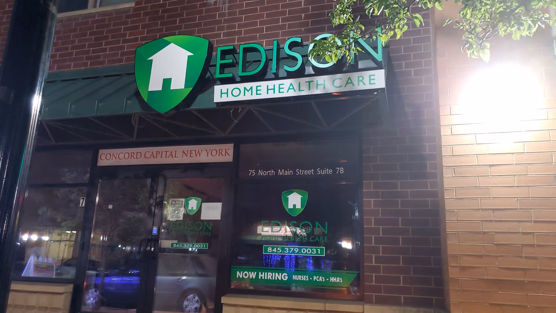 Exterior storefront of Edison Home Health Care with green shield logo and glass entrance