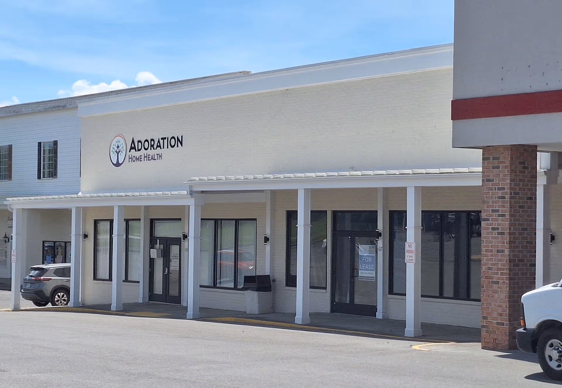 Front view of Adoration Home Health building exterior with a covered entrance.