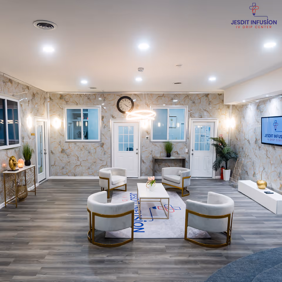 Modern lounge area in a senior facility with white chairs and a central coffee table.