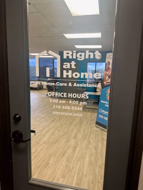 Glass door bearing Right at Home logo opens to a lobby with office signage.