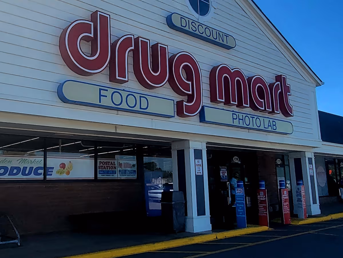 Front of Discount Drug Mart store with large red logo and signage.