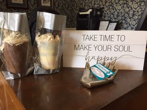Counter with two wrapped pastries and a sign reading Take time to make your soul happy.
