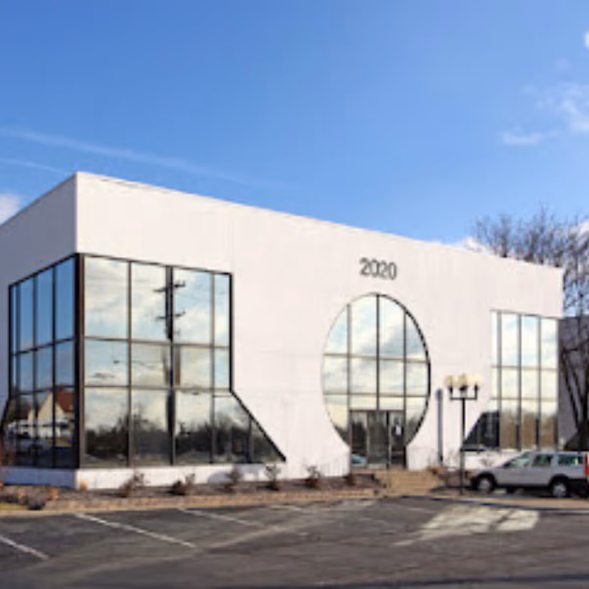 Exterior of a modern building with large glass windows and a circular central window.