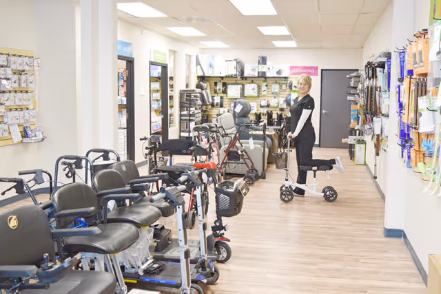 Interior showroom at Life Care HME Medical Supply with mobility devices and staff.