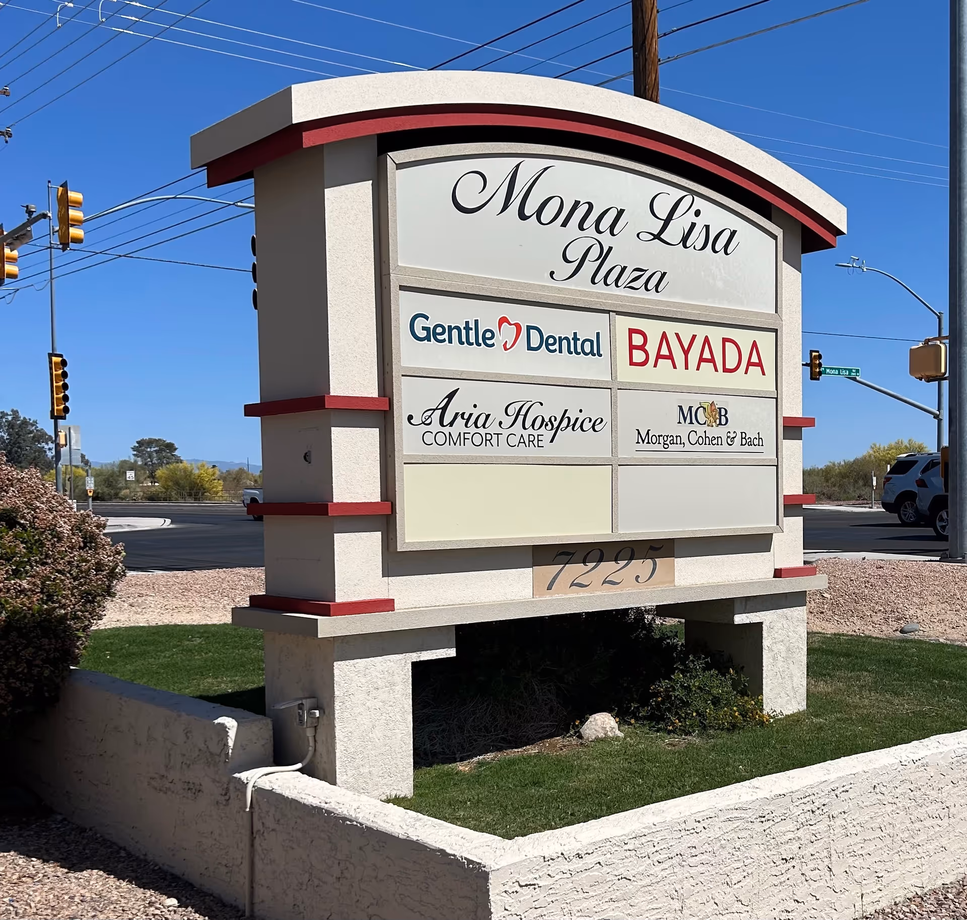 Outdoor plaza signboard for Mona Lisa Plaza featuring BAYADA, Gentle Dental, and Aria Hospice.
