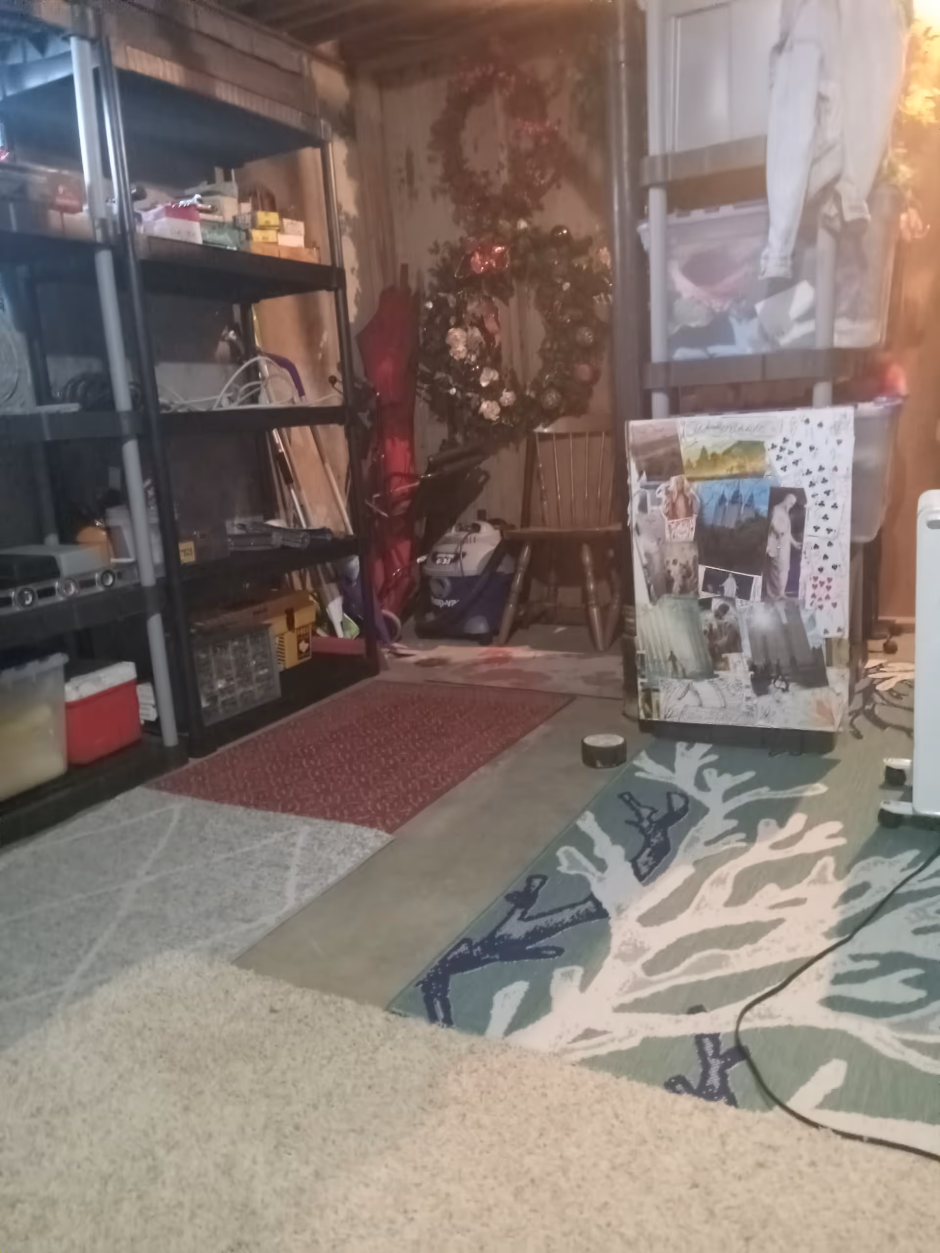 Cluttered interior storage area with metal shelves, rugs, and assorted items.