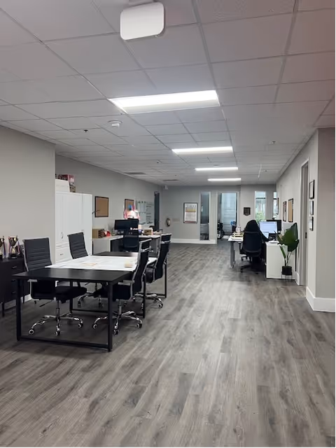 Open interior workspace with desks, chairs, and computers at BAYADA Assistive Care.