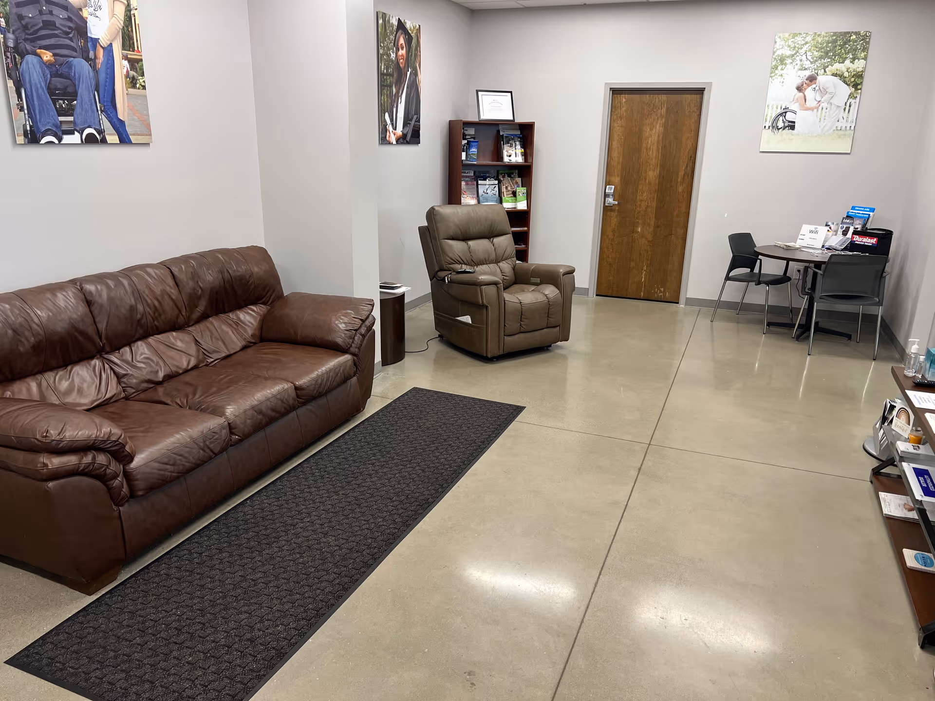 Senior living facility lobby with leather sofa, recliner, desk, and brochures.