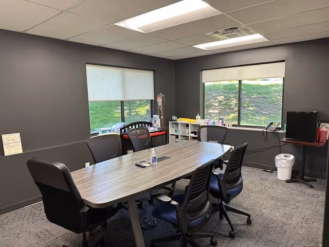 A modern conference room inside a BAYADA Pediatrics facility with a large table.