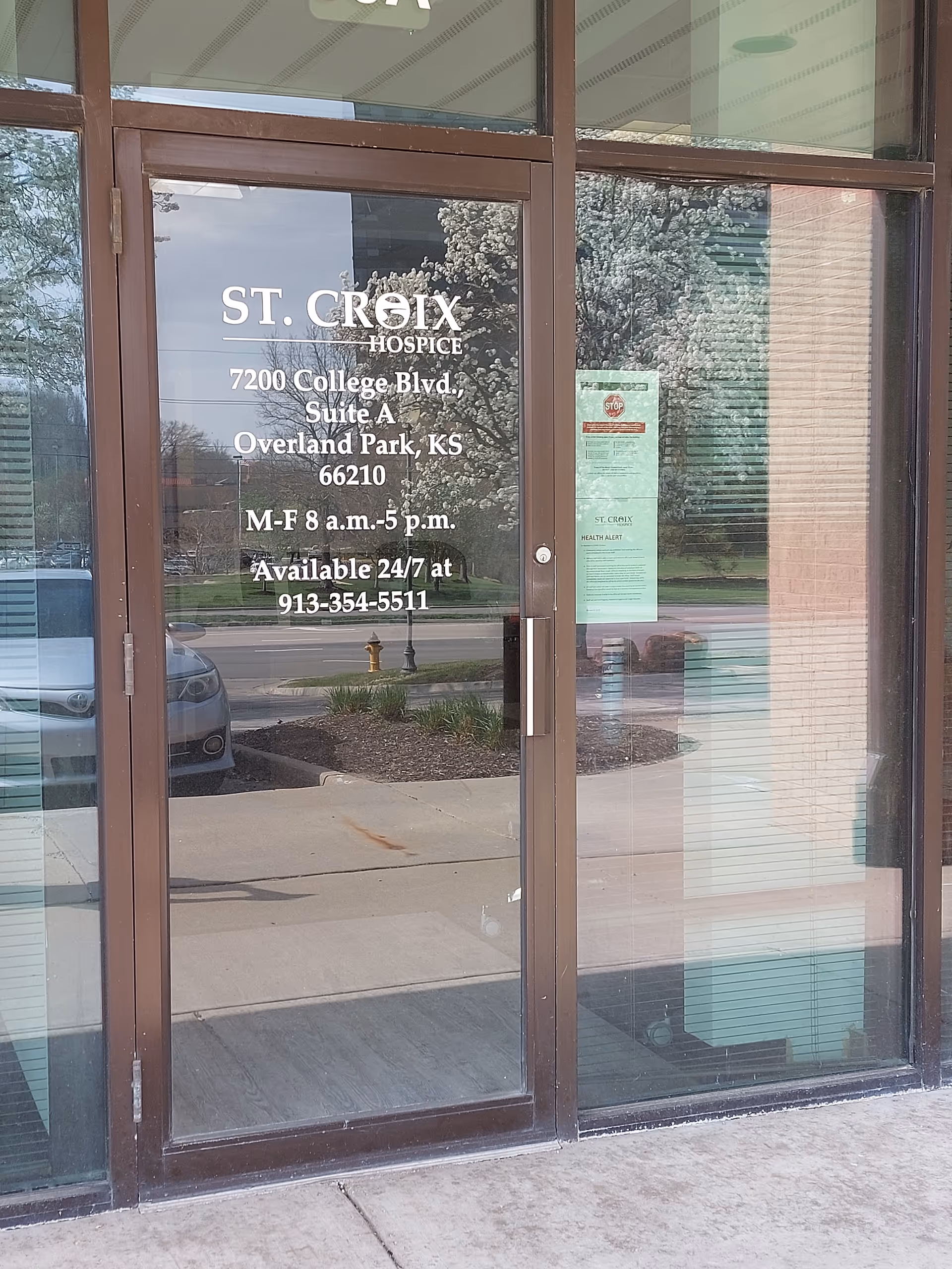 Glass door entrance featuring St. Croix Hospice signage and address in Overland Park, Kansas.