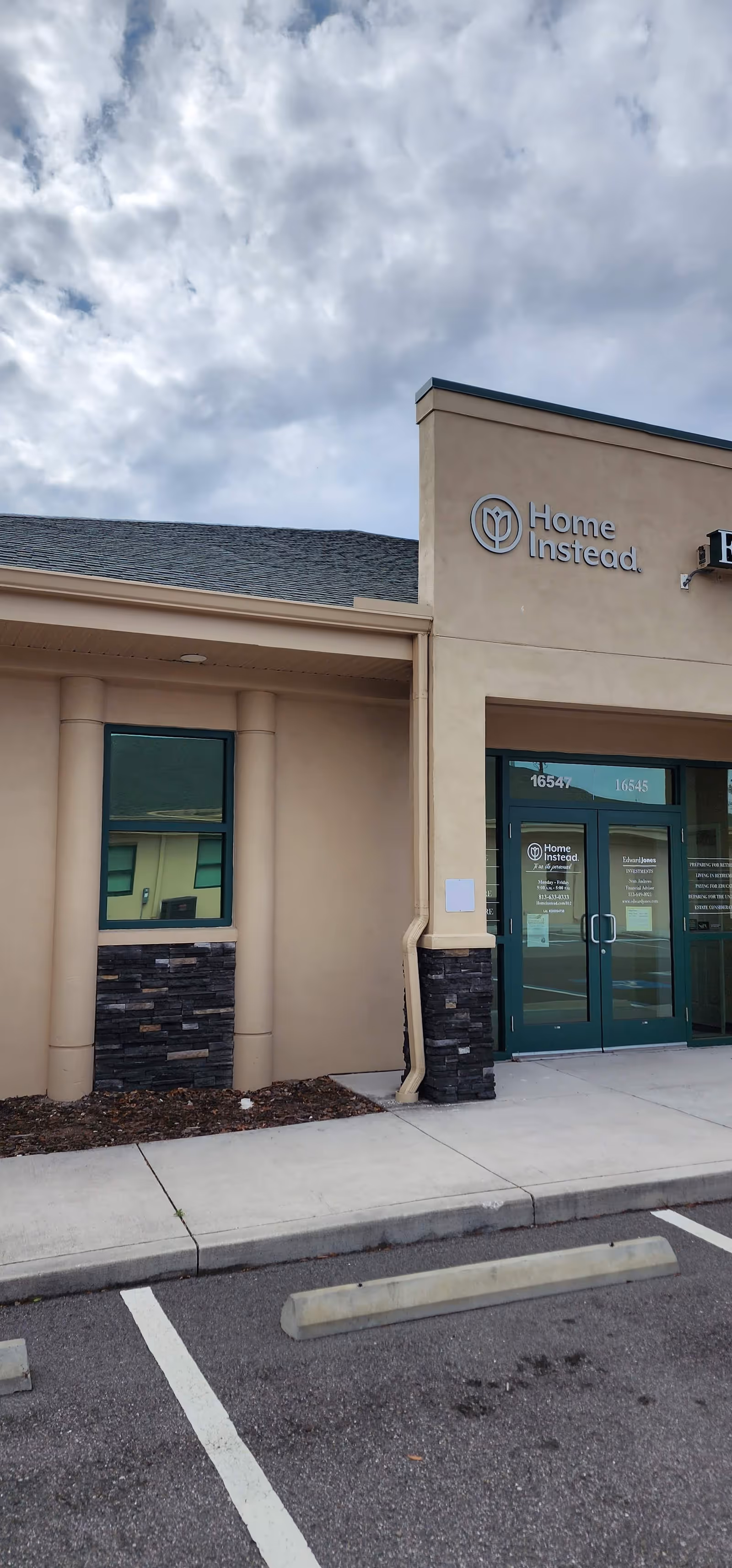 Exterior view of a Home Instead facility with glass doors and signage.