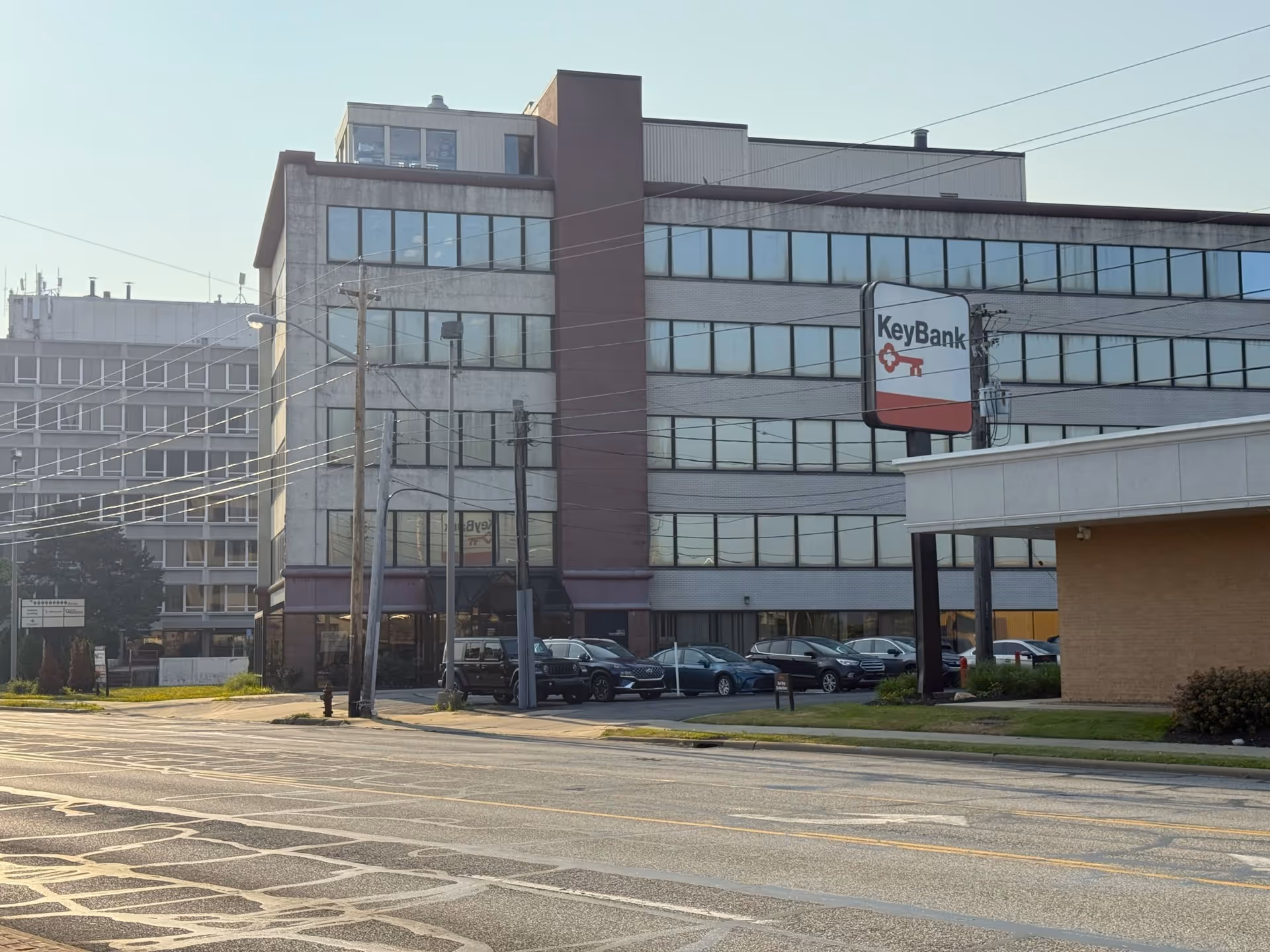 Exterior view of a multi-story building with a KeyBank sign along the street.