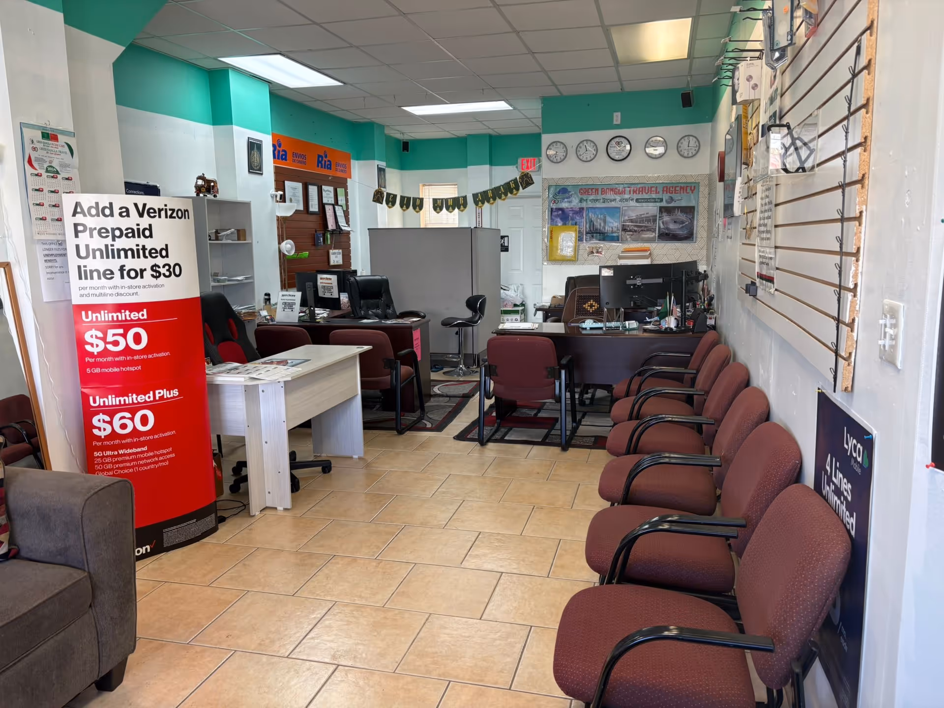Green-accented reception area with chairs, desks, and travel agency signage in view.