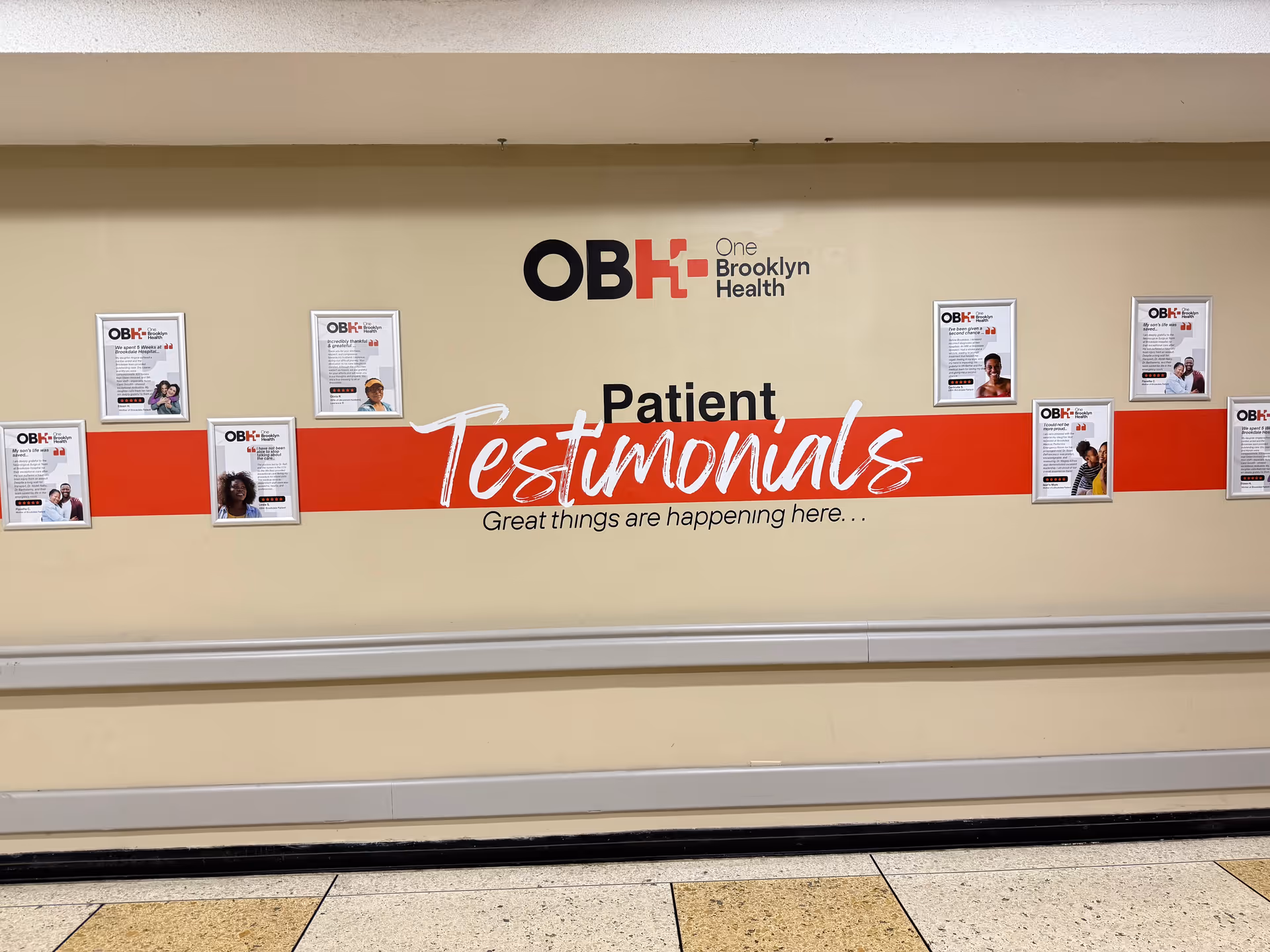 Interior hospital hallway wall with patient testimonials panels.