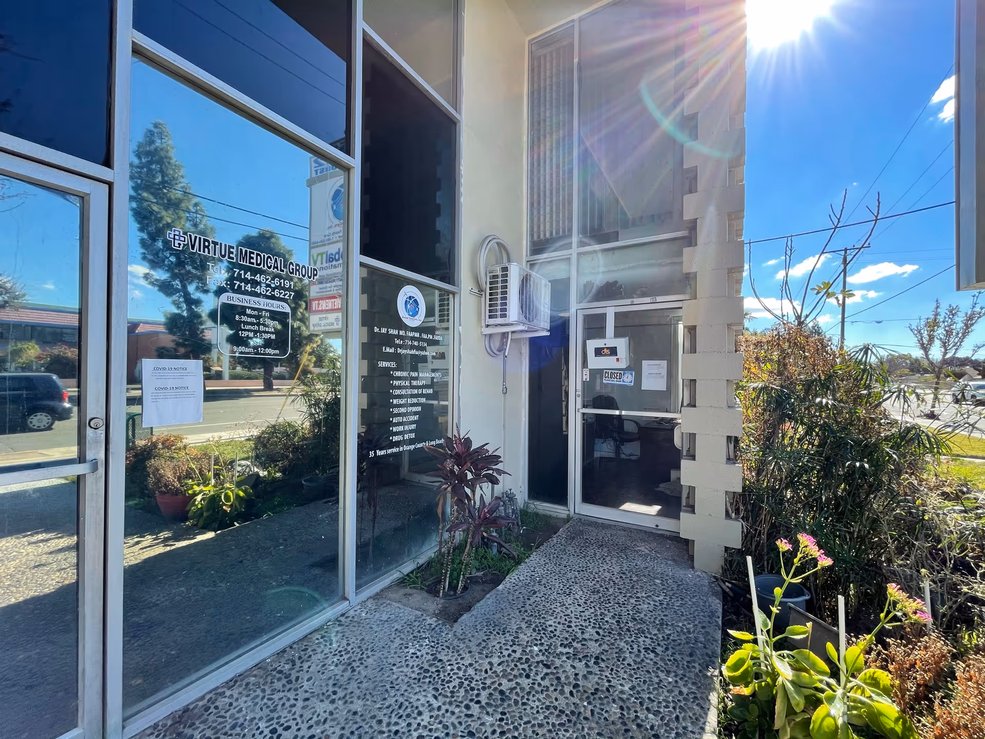 Front entrance of Virtue Medical Group Garden Grove with glass doors and plants