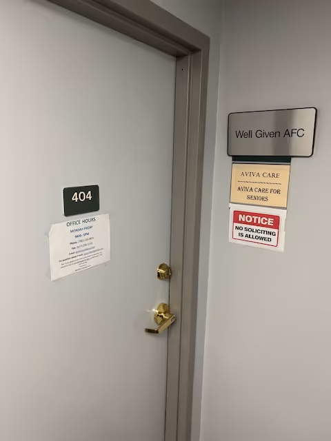 Interior hallway with a gray door labeled 404 and posted notices.
