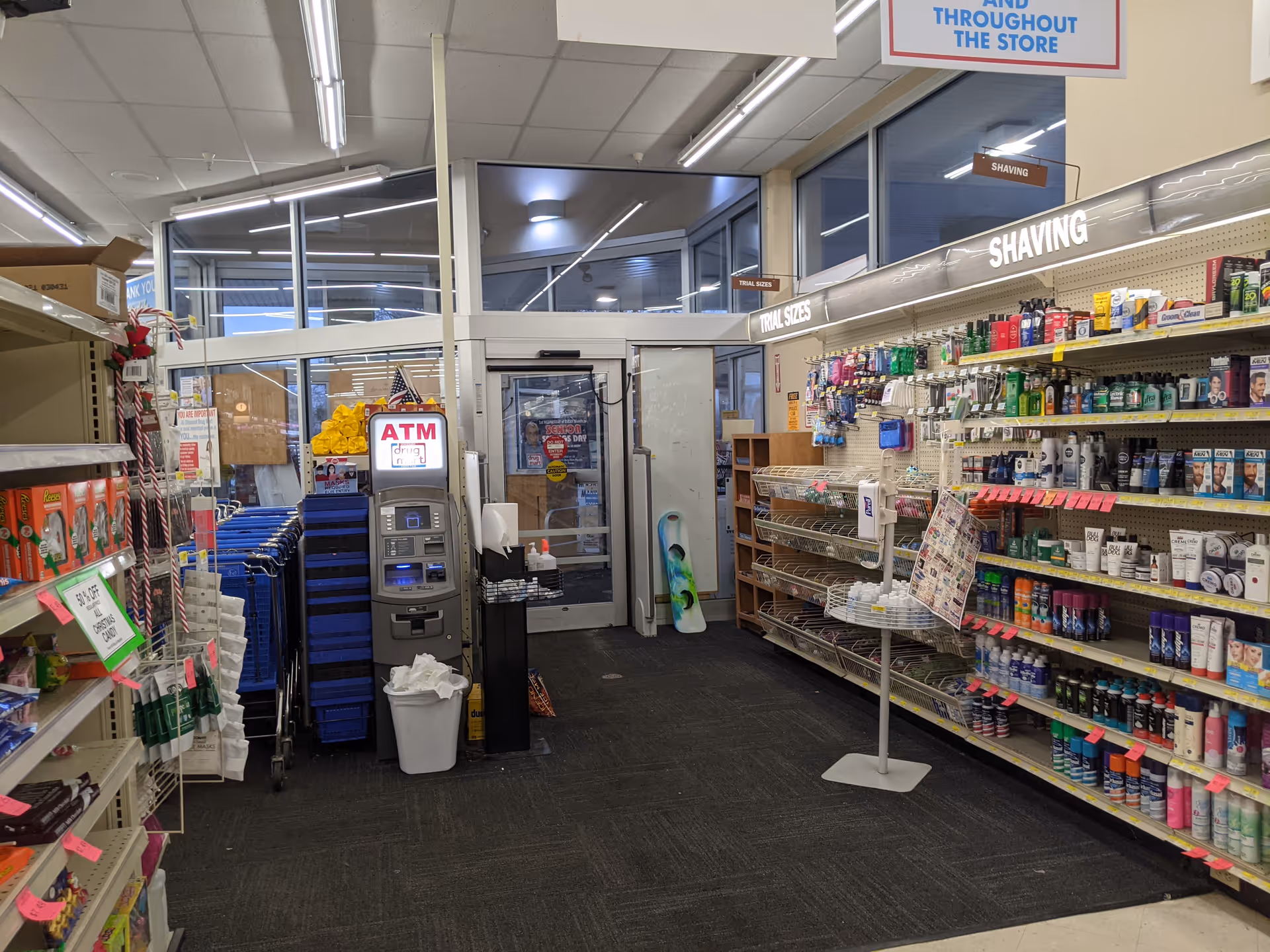 Interior of Discount Drug Mart store with aisles, shelves, and an ATM.