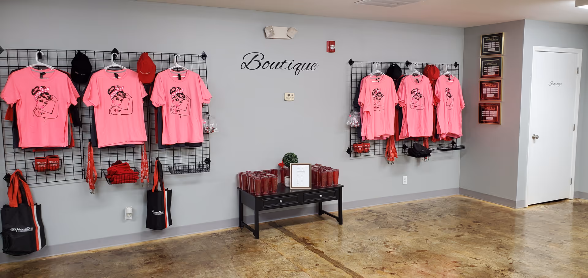 Boutique display in a senior facility with pink t-shirts on racks