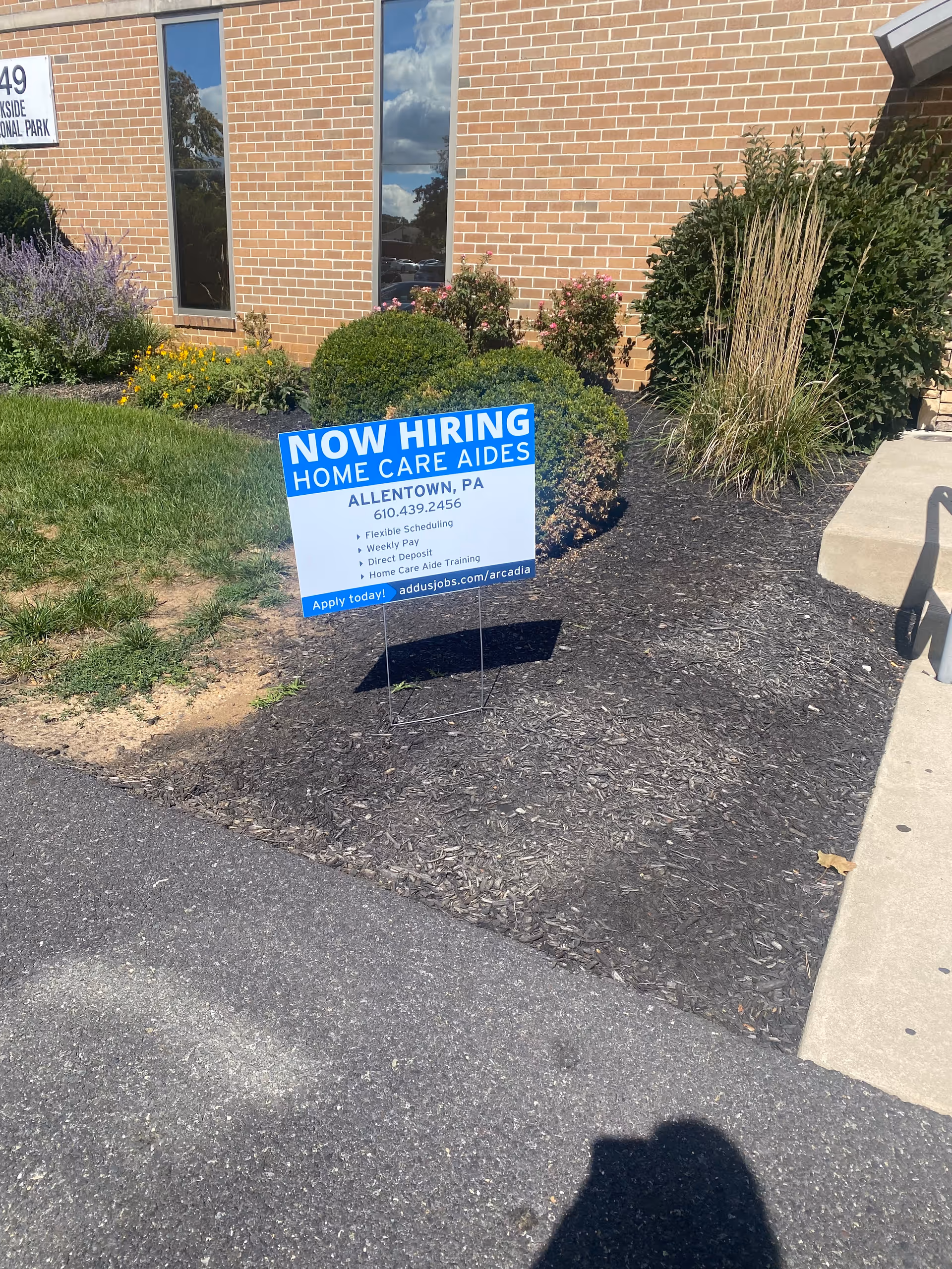 Arcadia Home Care and Staffing exterior with a blue Now Hiring sign in front.