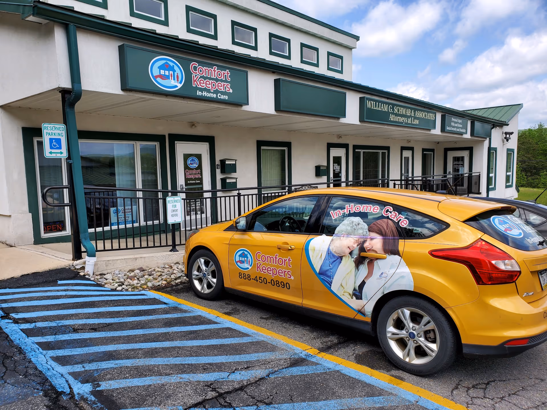 Exterior view of Comfort Keepers storefront with a branded yellow car parked in front.