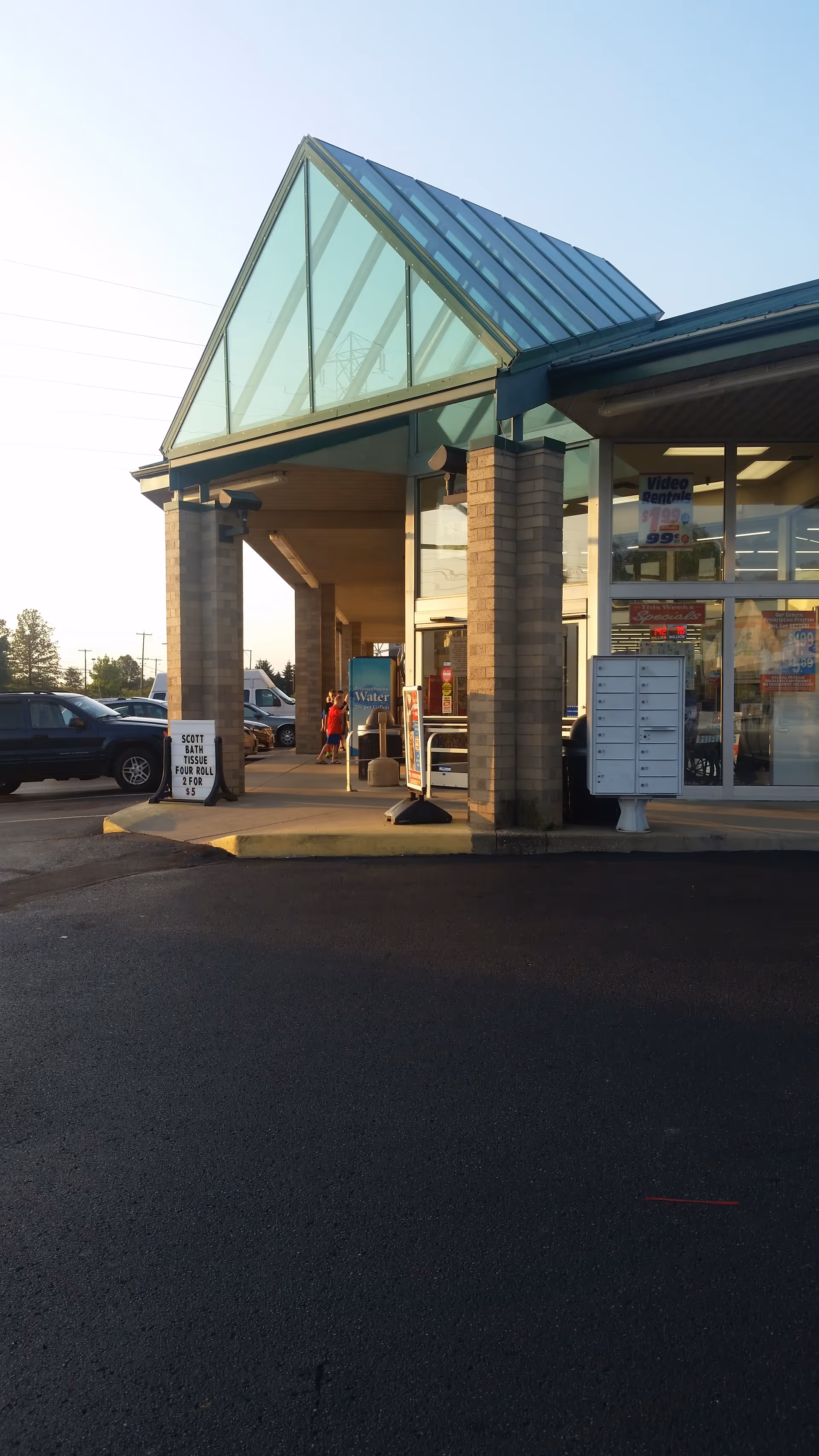 Discount Drug Mart storefront with glass front and brick columns in a parking lot.